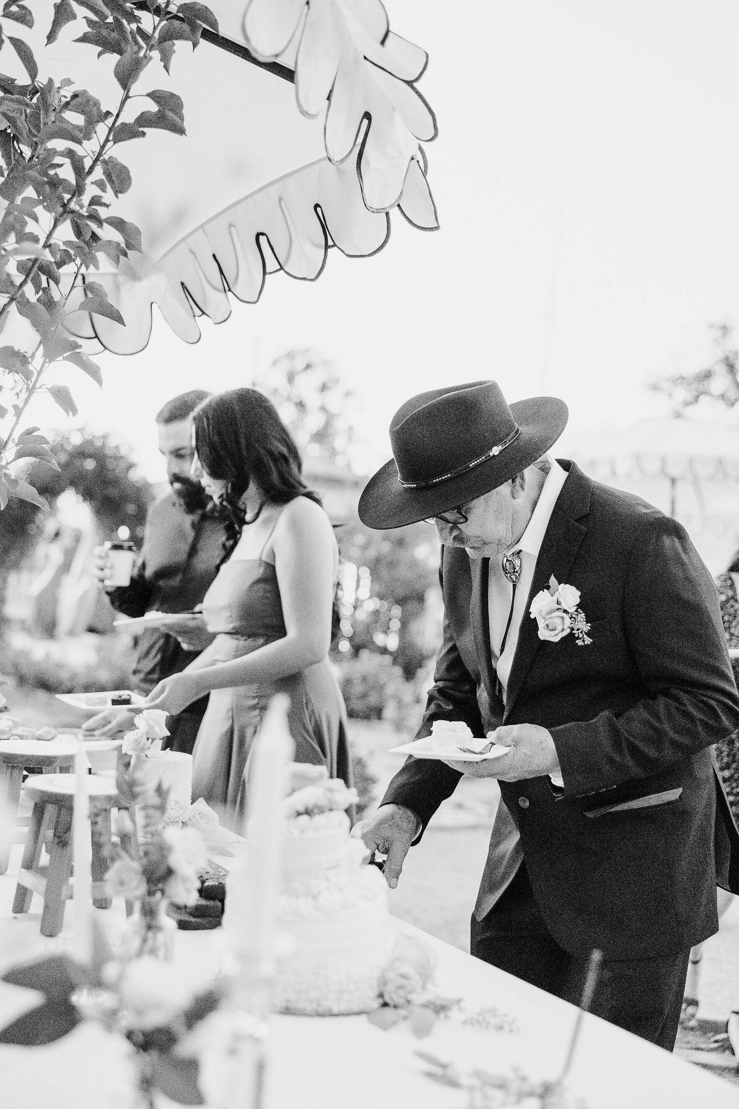 Vintage-style black and white photos of a couple sharing intimate moments at their wedding.