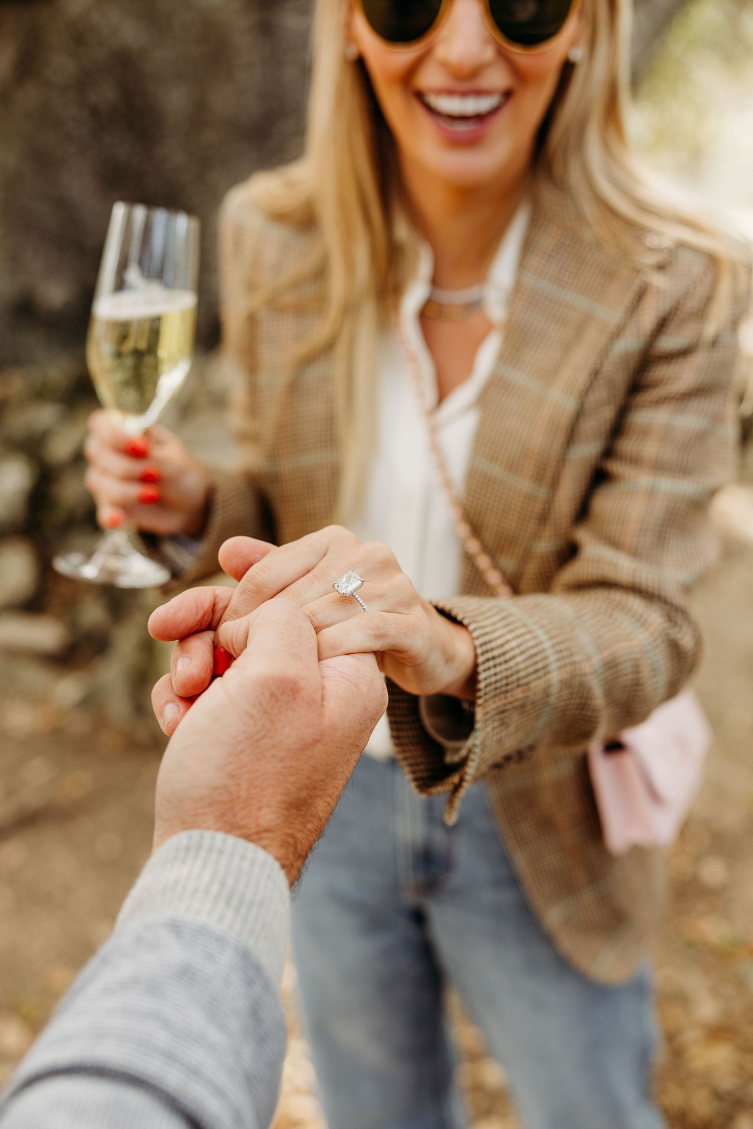 Close-up of champagne glasses being held during an outdoor celebration.