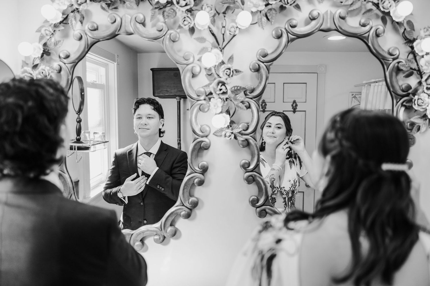 Black and white wedding ceremony photos with ornate floral arch decorations.