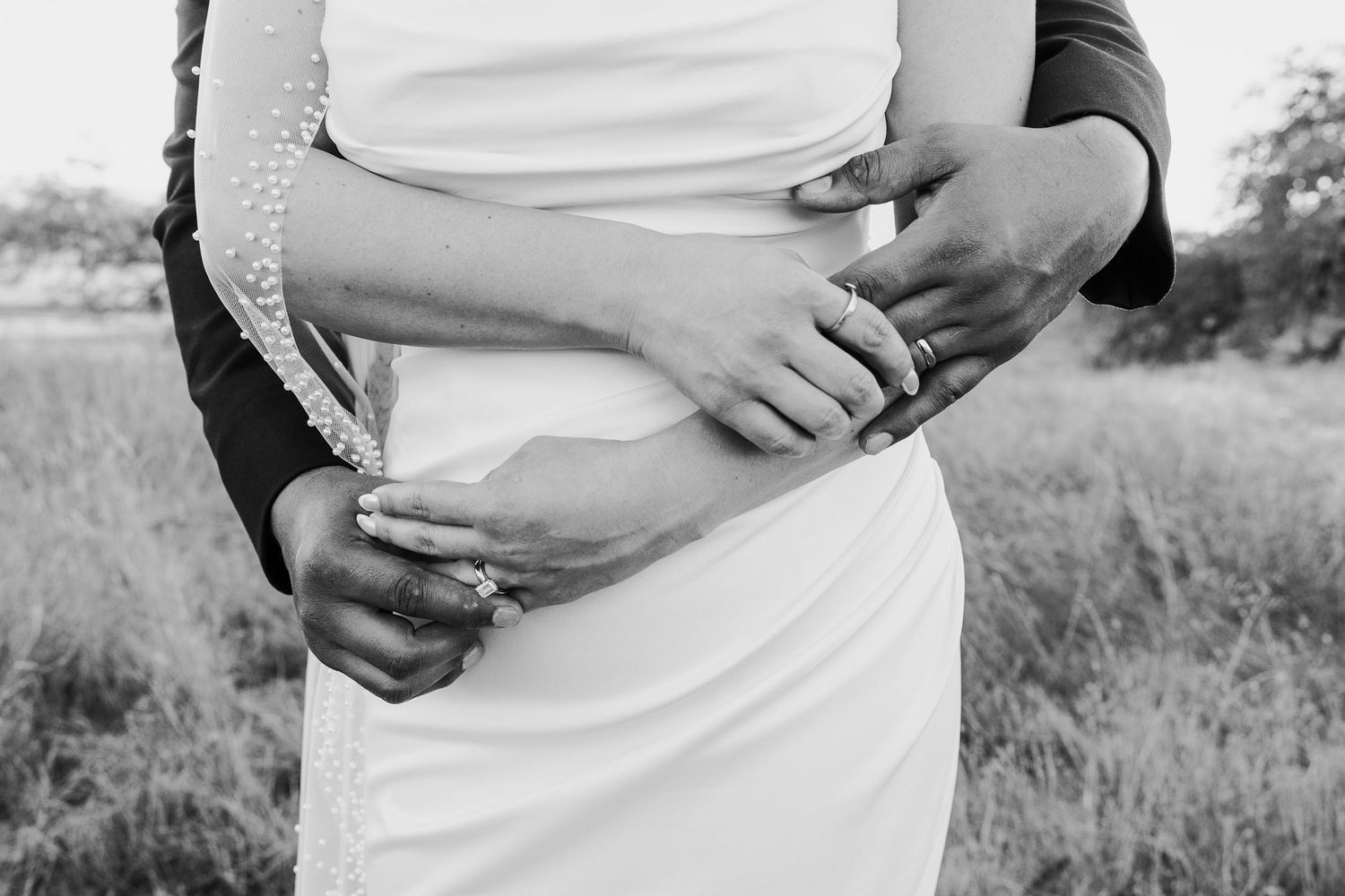 Intimate maternity photo session capturing loving moments in natural outdoor setting.