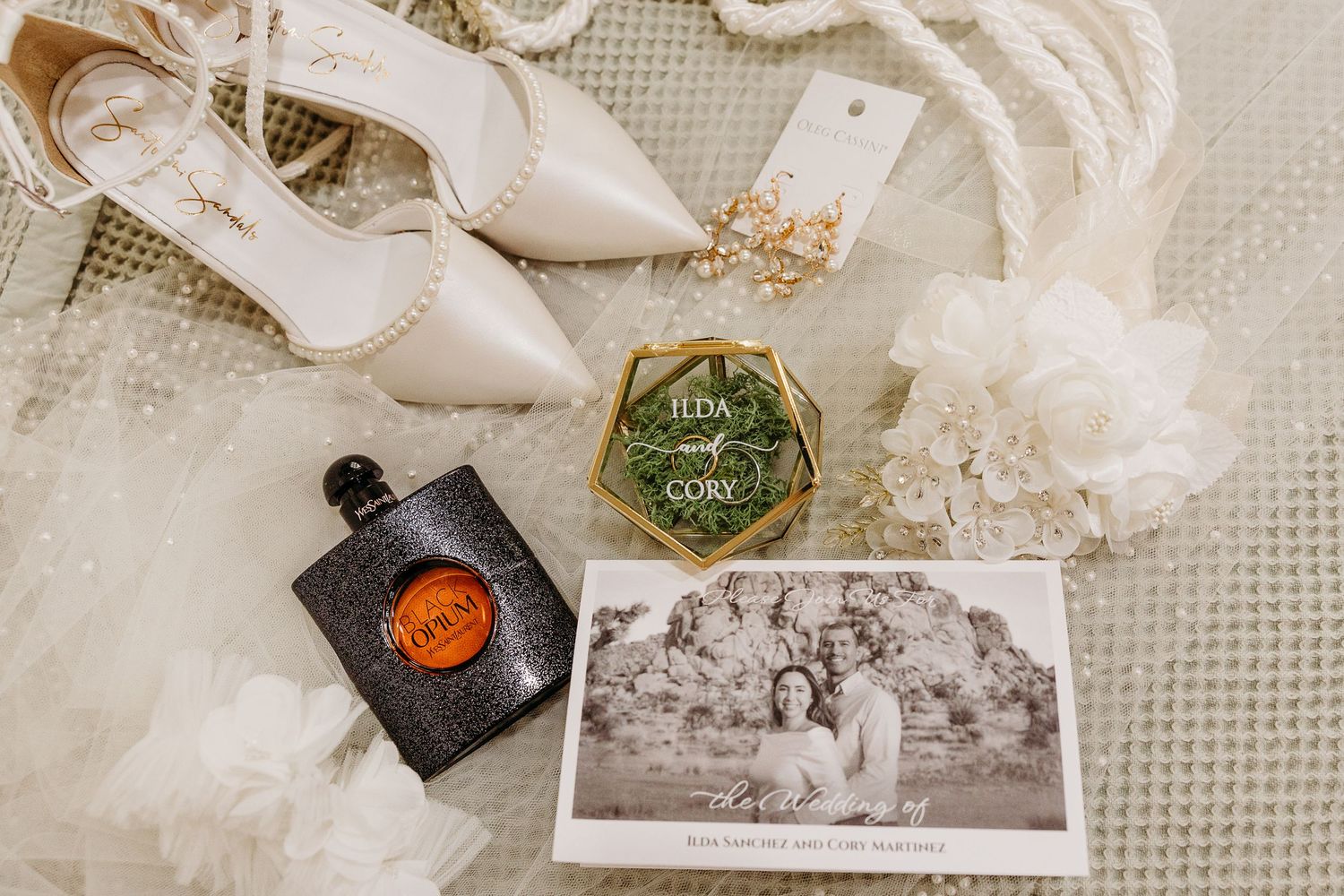 Vintage wedding details including lace, ribbons, and old photographs arranged in an artistic flatlay composition.