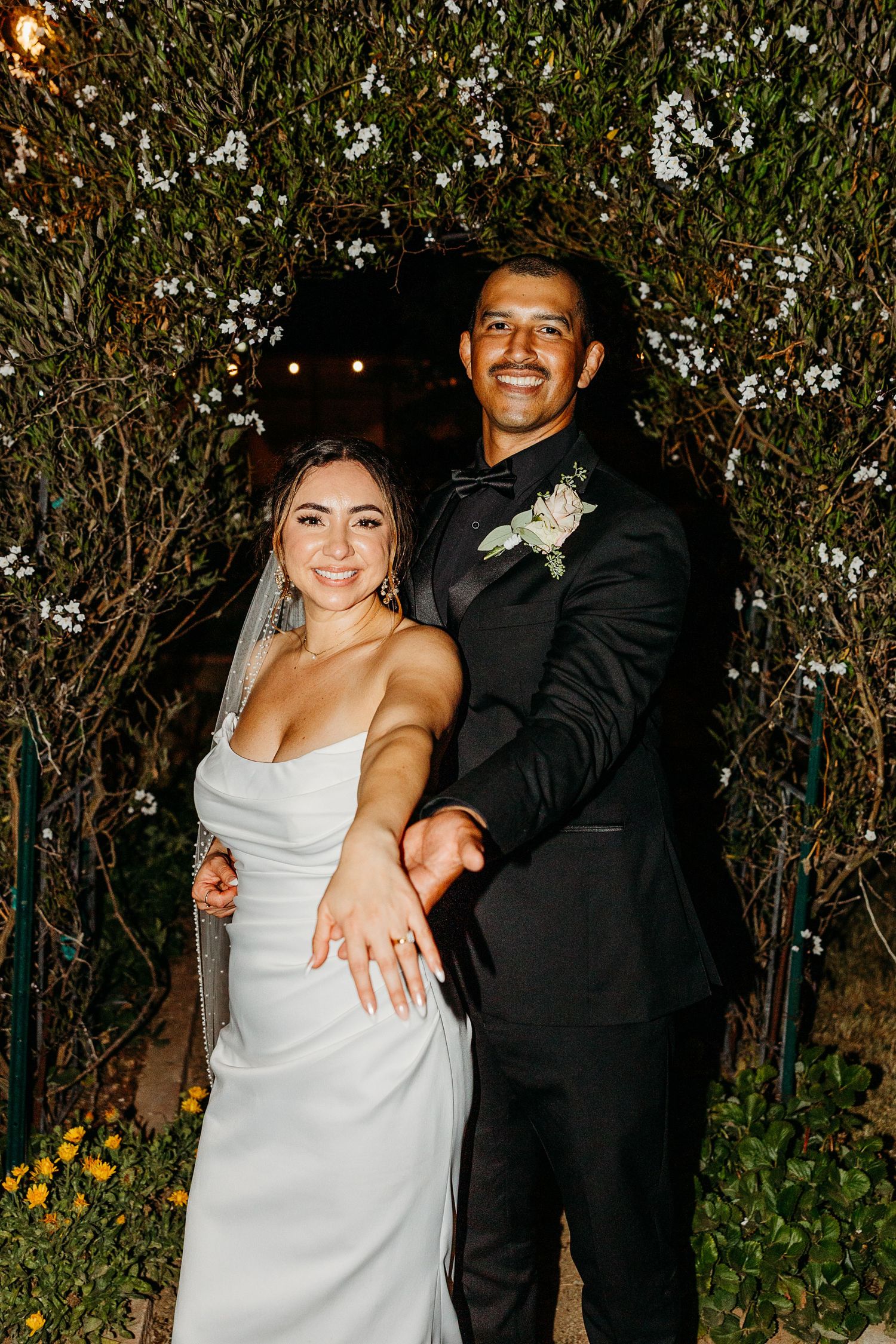 Couple enjoying a fun moment together at an evening outdoor celebration.