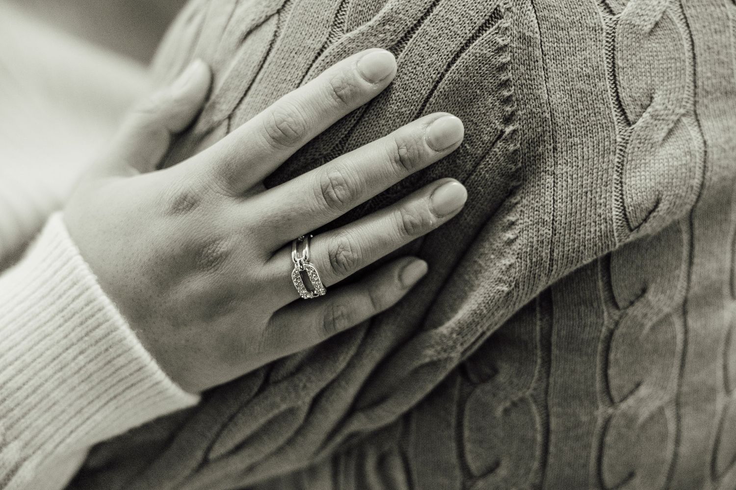 Close-up series of hands touching a cable knit sweater texture in black and white photography.