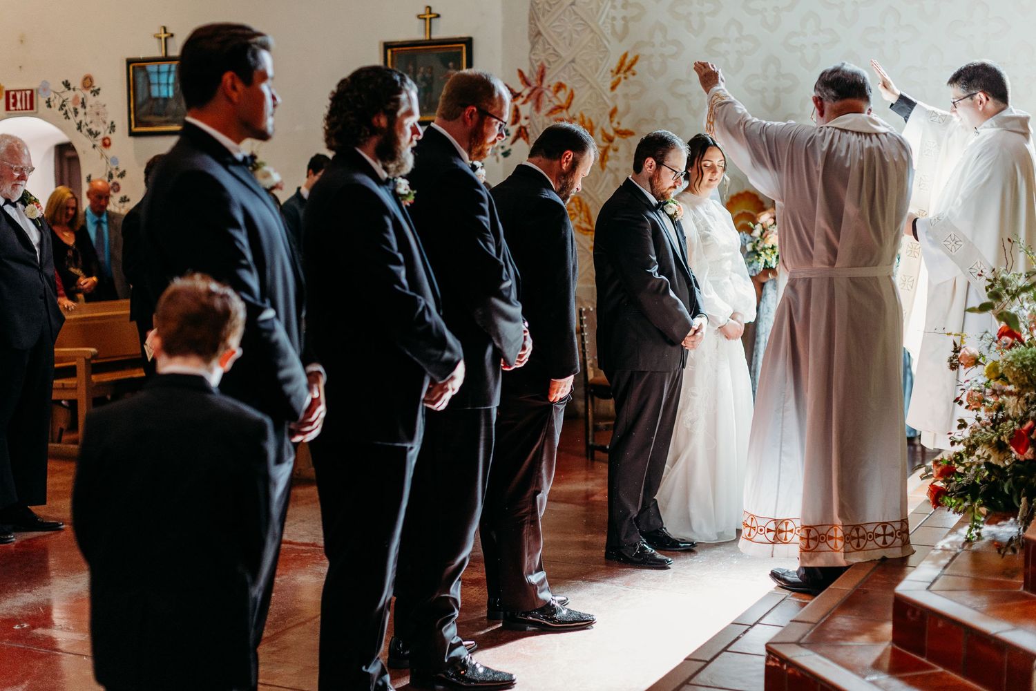 Catholic wedding ceremony with priest and wedding party at altar in San Luis Obispo.
