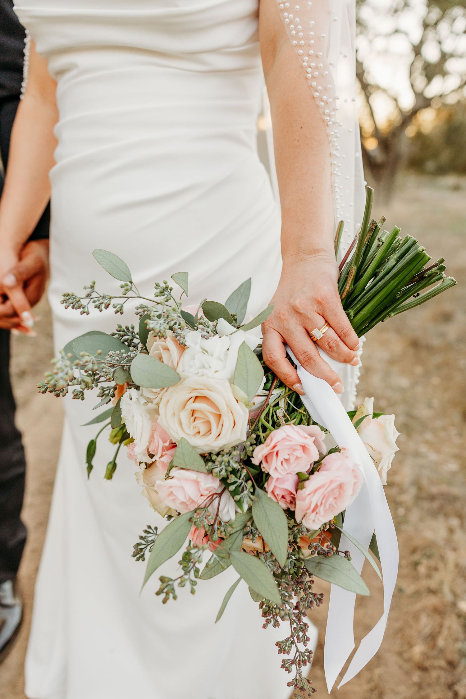 Elegant bridal bouquet with blush roses, white flowers and eucalyptus.