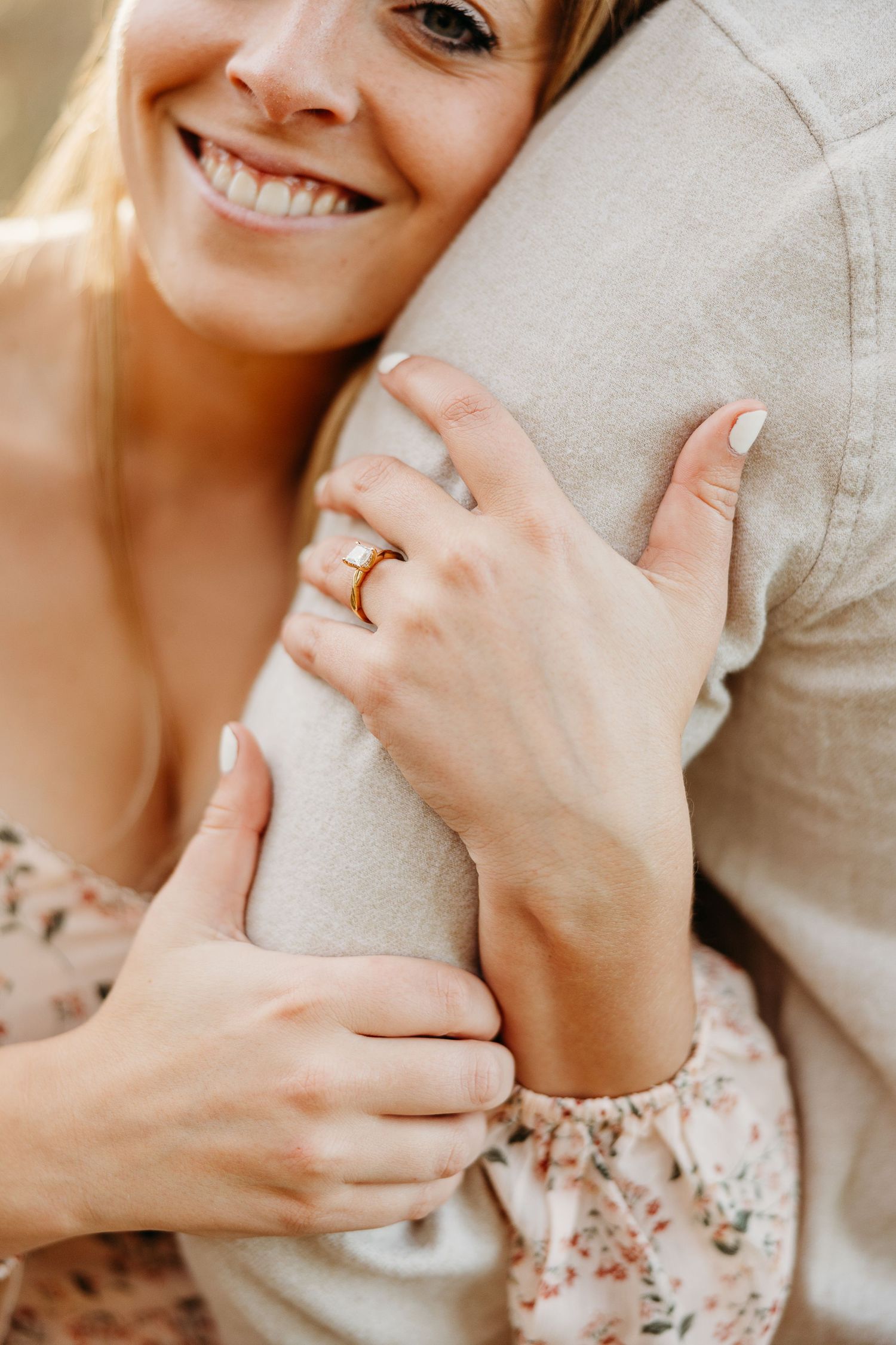Close up shot showing hands and engagement ring during outdoor photo session.