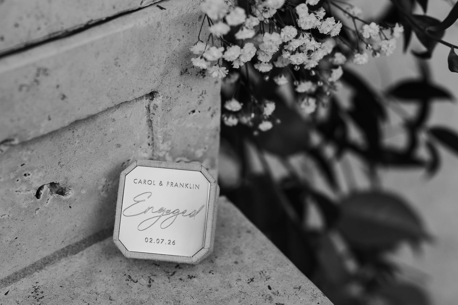 Black and white detail shots of wedding place cards with elegant calligraphy displayed on a textured surface.