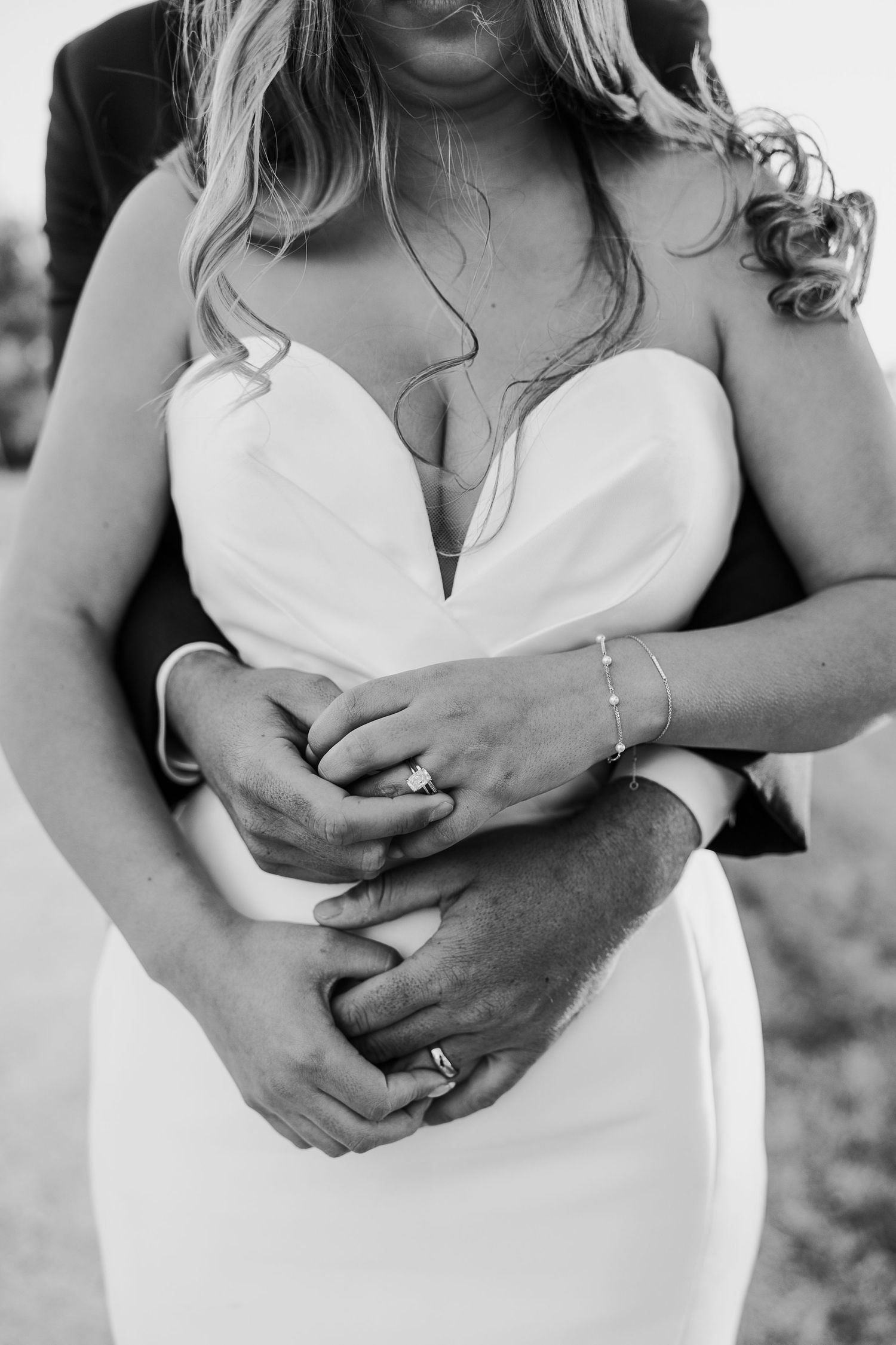 Intimate black and white close-up shots of a couple embracing in wedding attire.