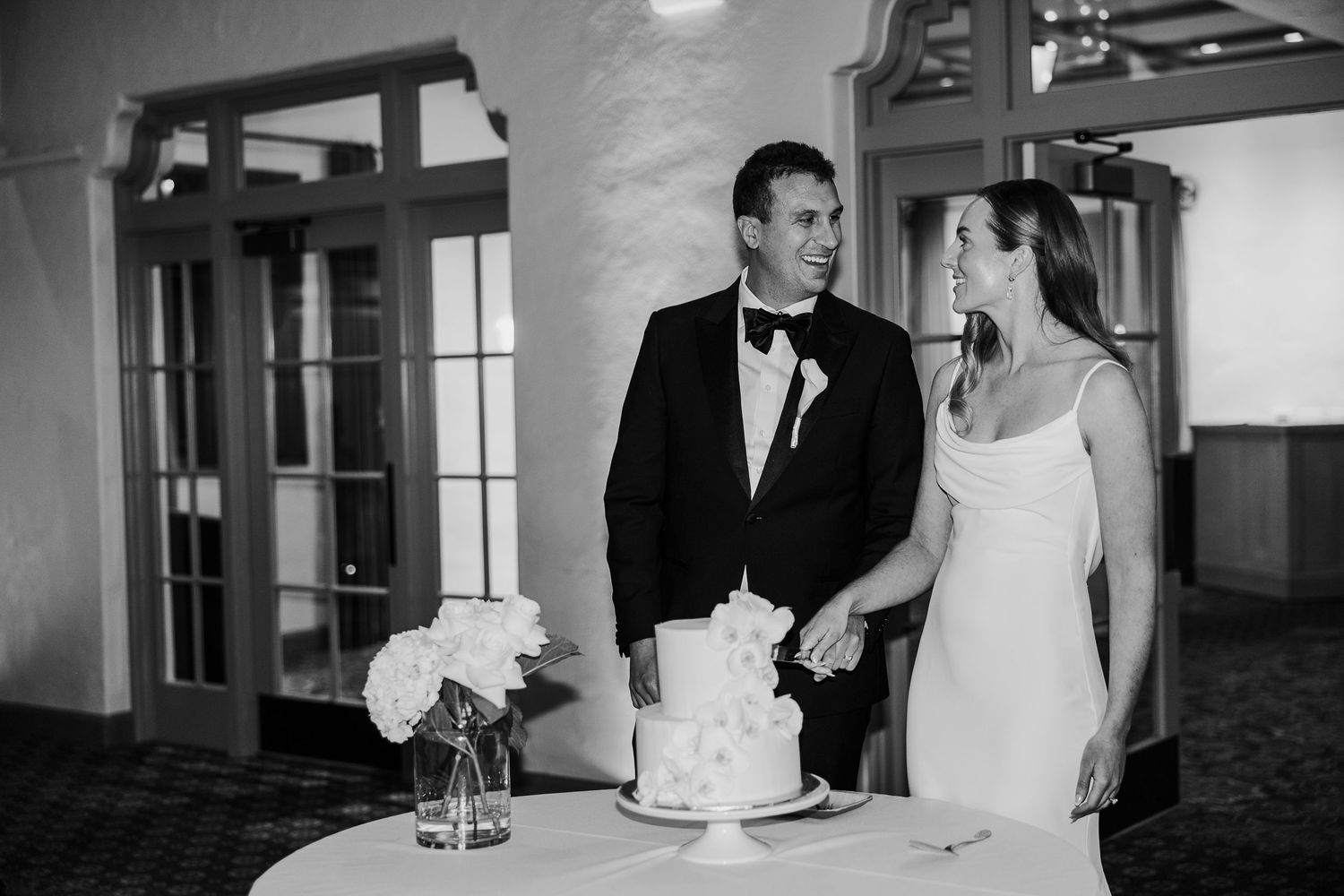 Black and white wedding reception photos showing couples dancing and celebrating.