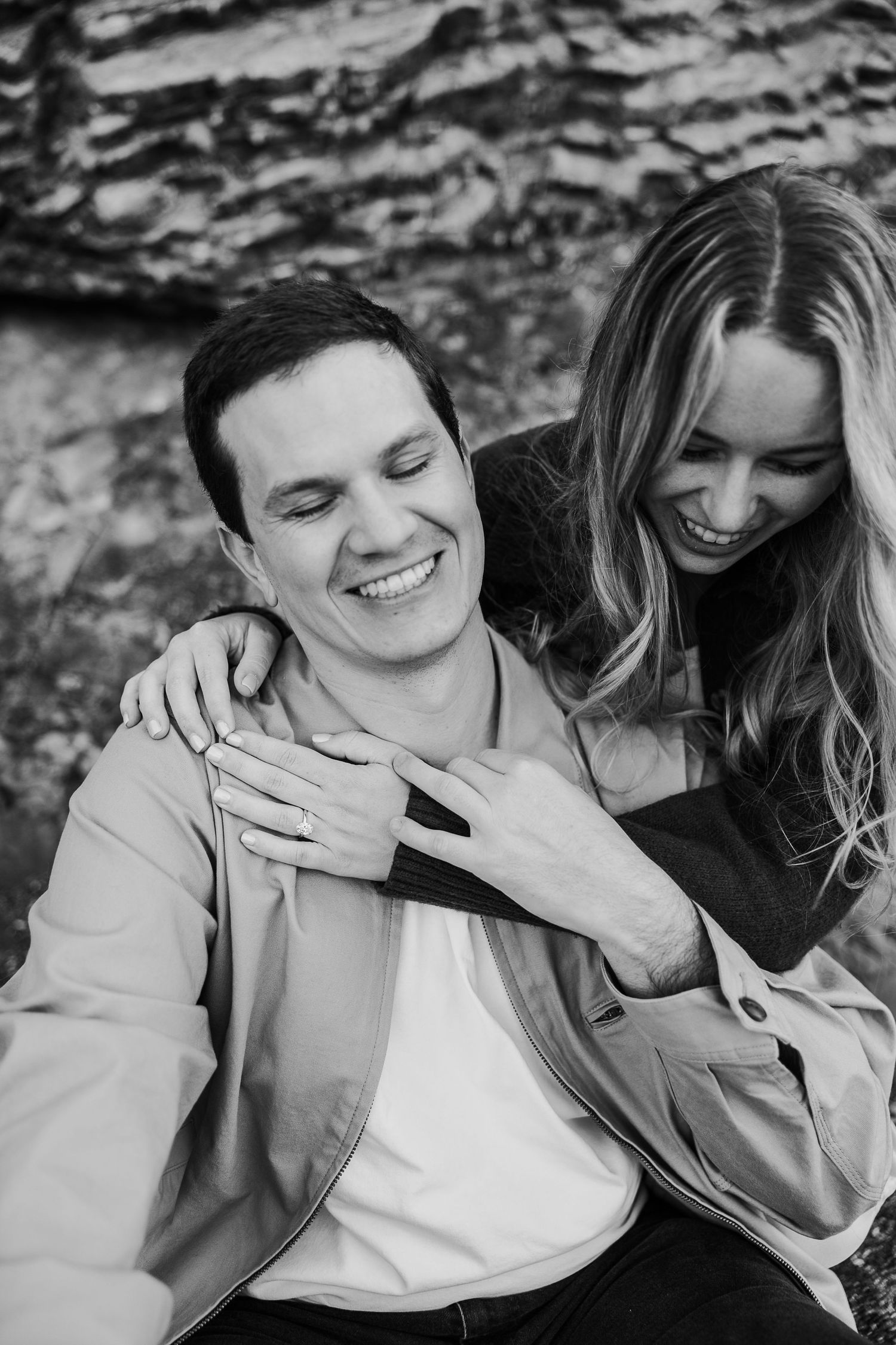 Black and white candid photos capturing intimate laughter and joy between a couple.