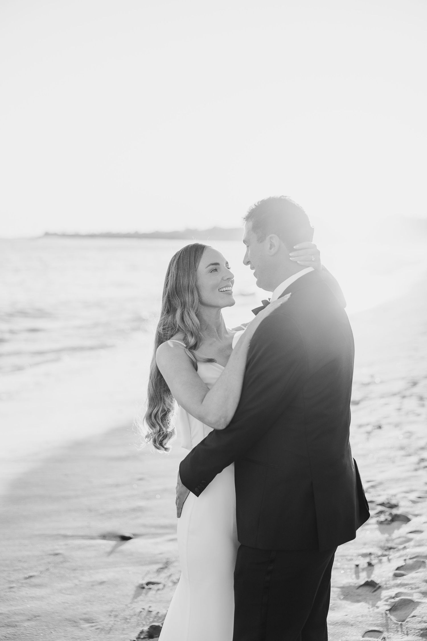 Intimate black and white wedding portraits by the ocean.