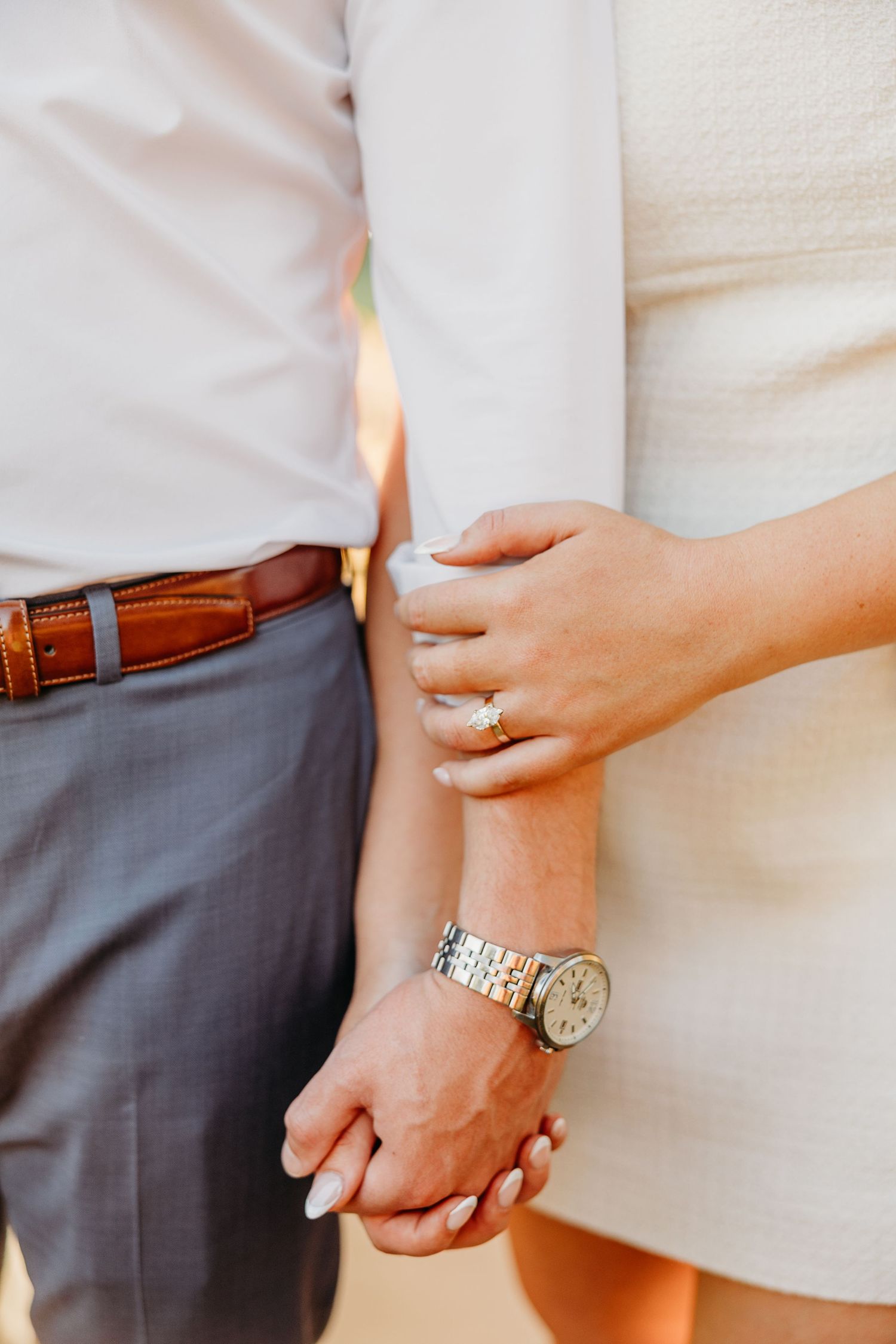 Close-up shots of hands holding each other, showing wedding rings and a wristwatch.