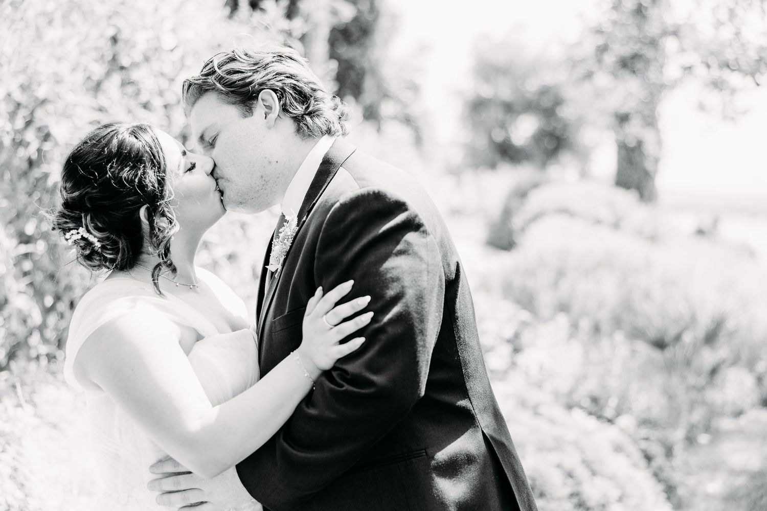 A tender black and white portrait of a couple sharing an intimate wedding moment.