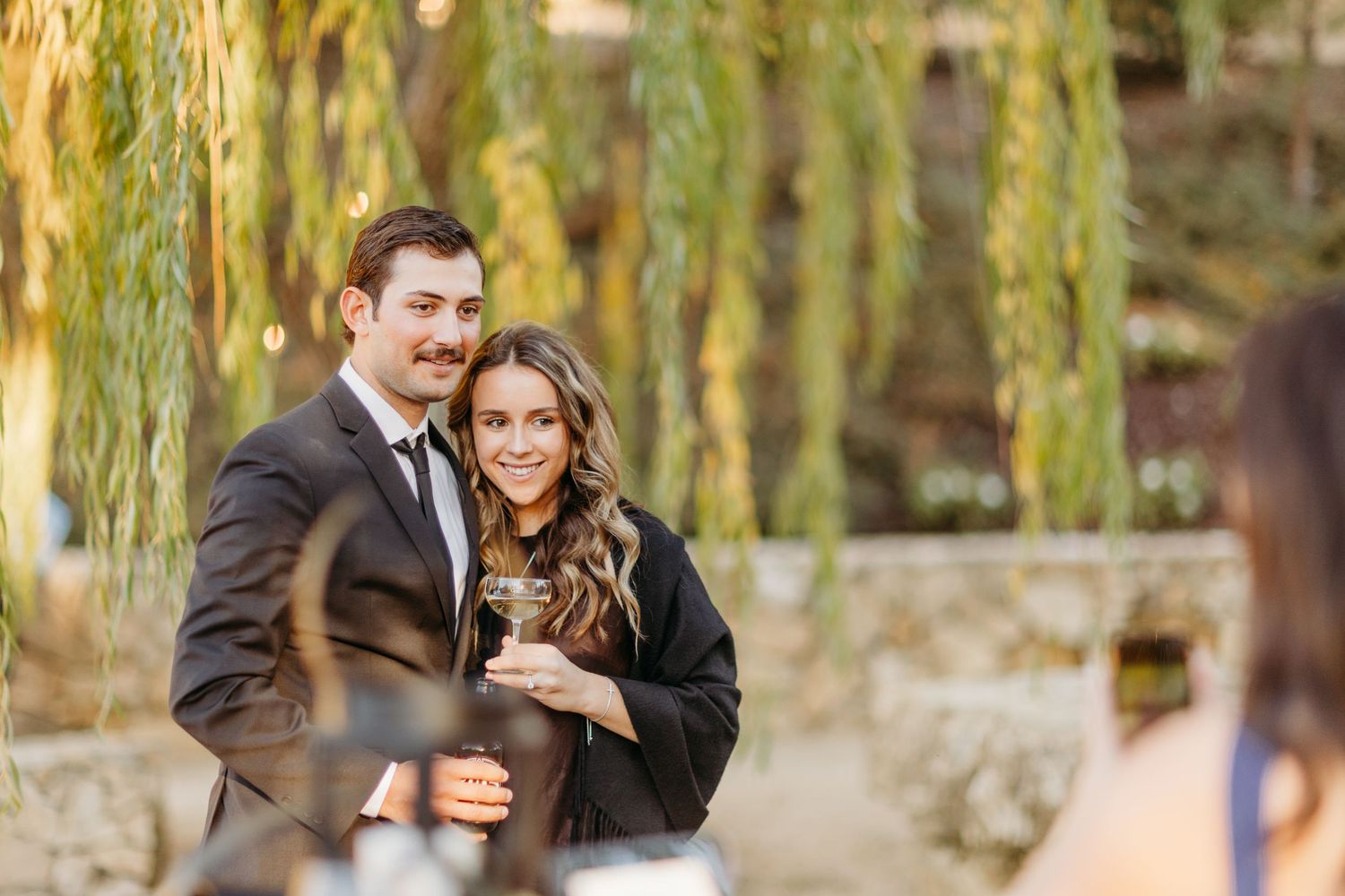 Romantic outdoor portrait in front of weeping willow trees.
