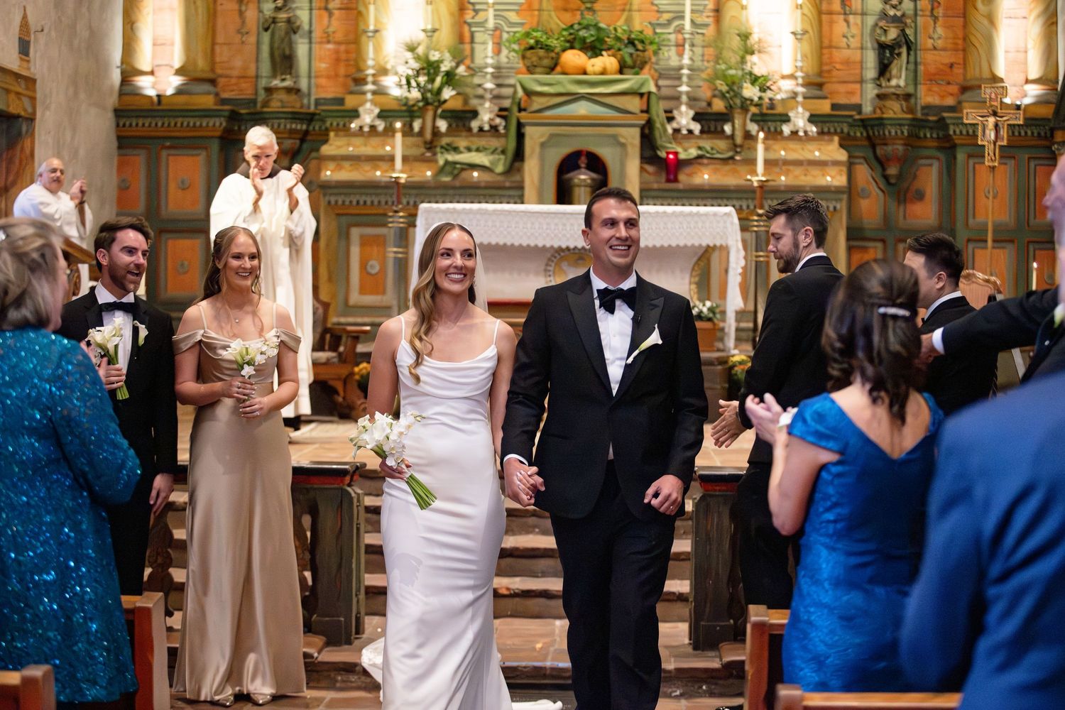 A wedding ceremony in a grand church with ornate decorations and guests celebrating the joyous occasion.