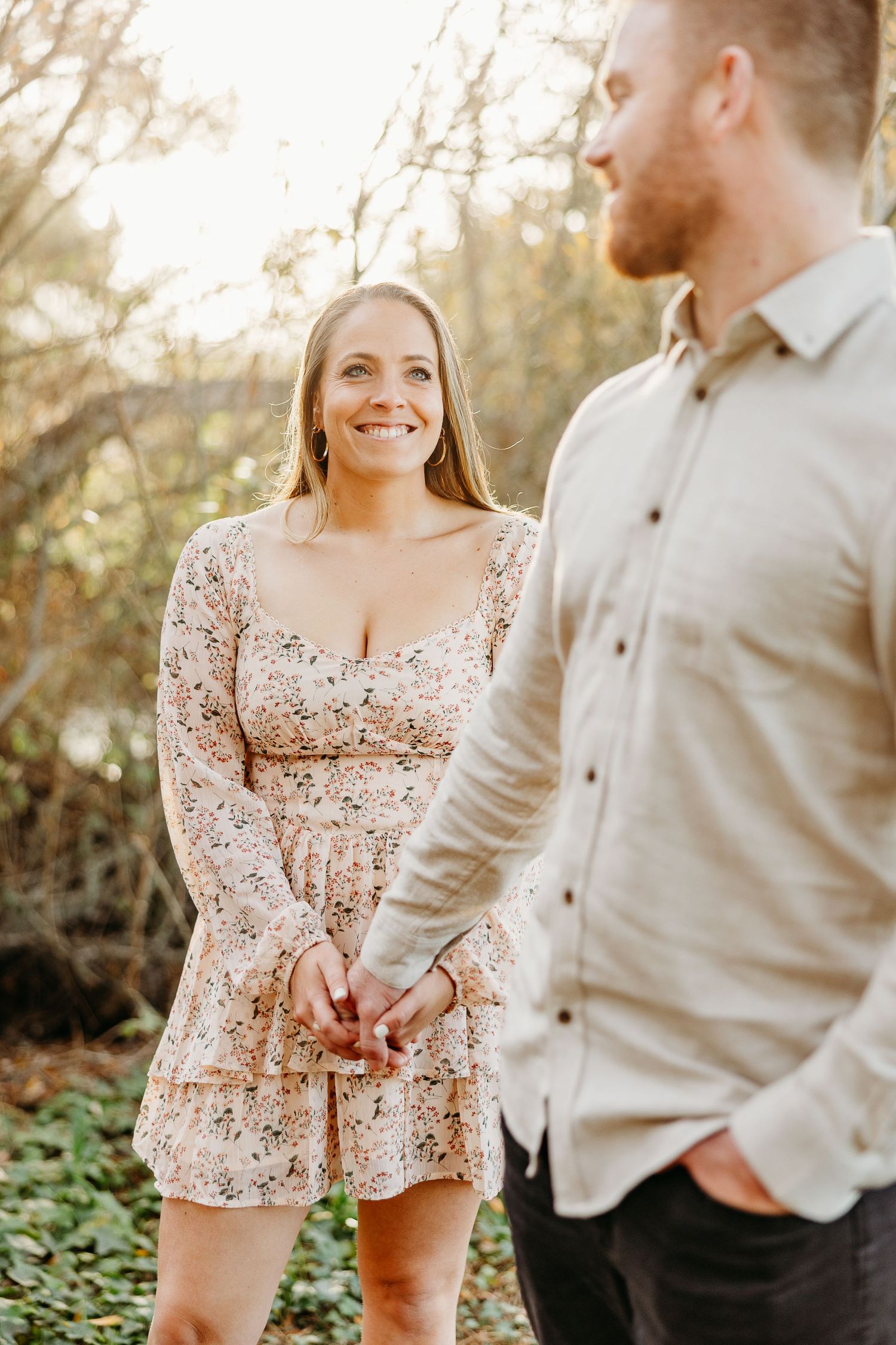 Couple shares joyful moment together outdoors in casual attire.