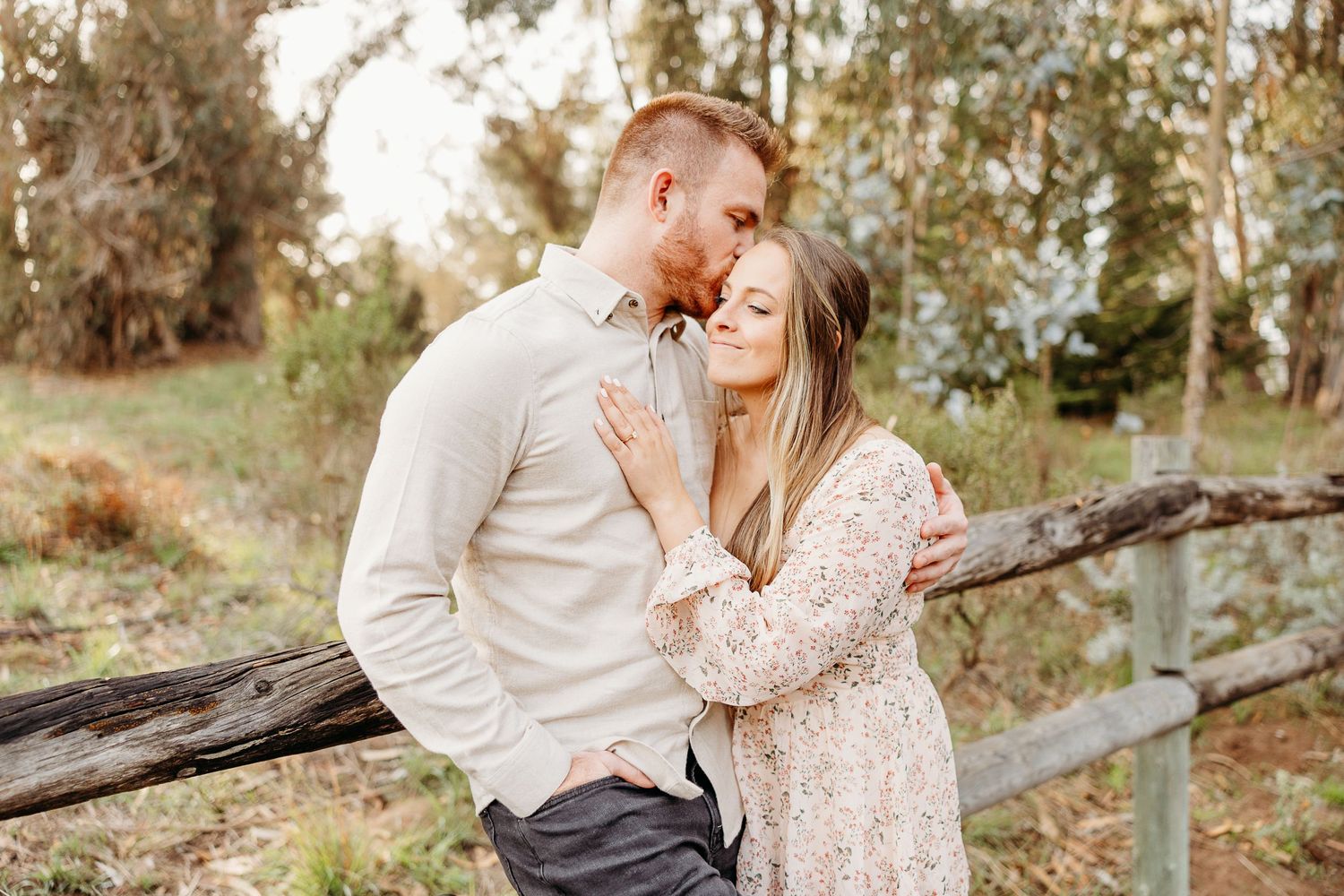 Couple sharing intimate moment together in rustic outdoor setting.