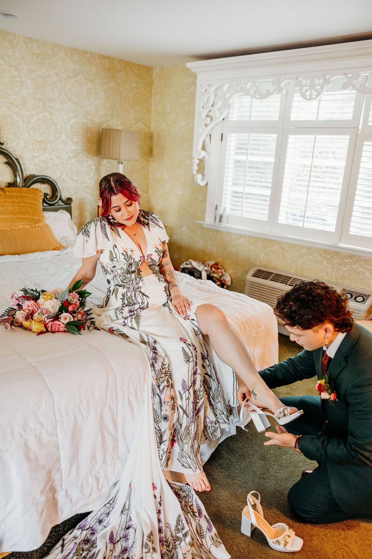A sequence showing someone adjusting a floral patterned dress on a bed in a sunlit room.