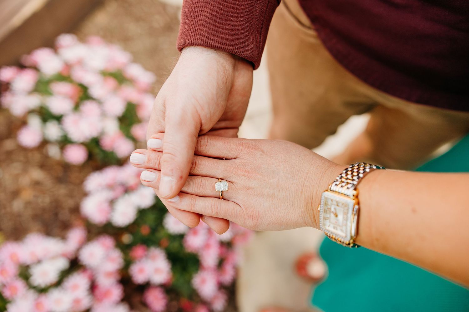 Close up shots of engagement rings and bracelets with pink flowers in background.
