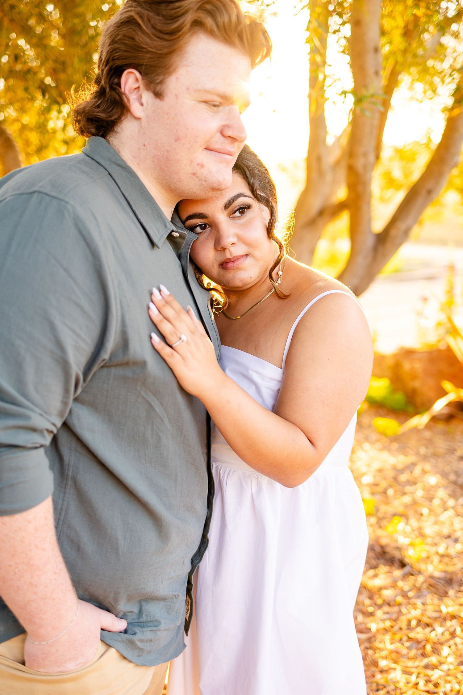A tender moment between two people captured in warm evening light.