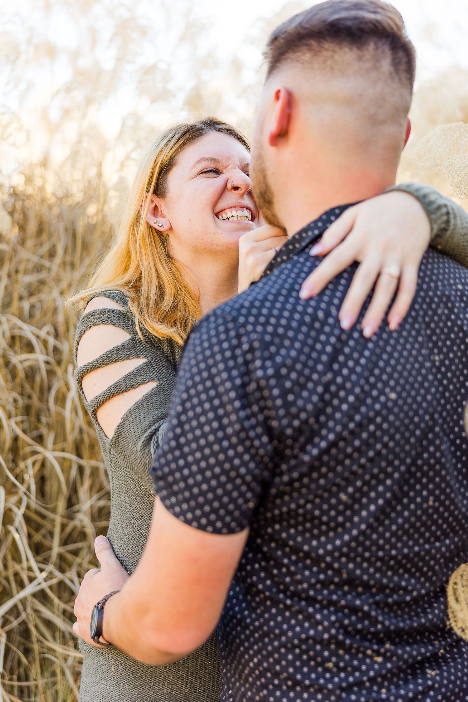 A joyful moment captured between a couple during their outdoor photo session.