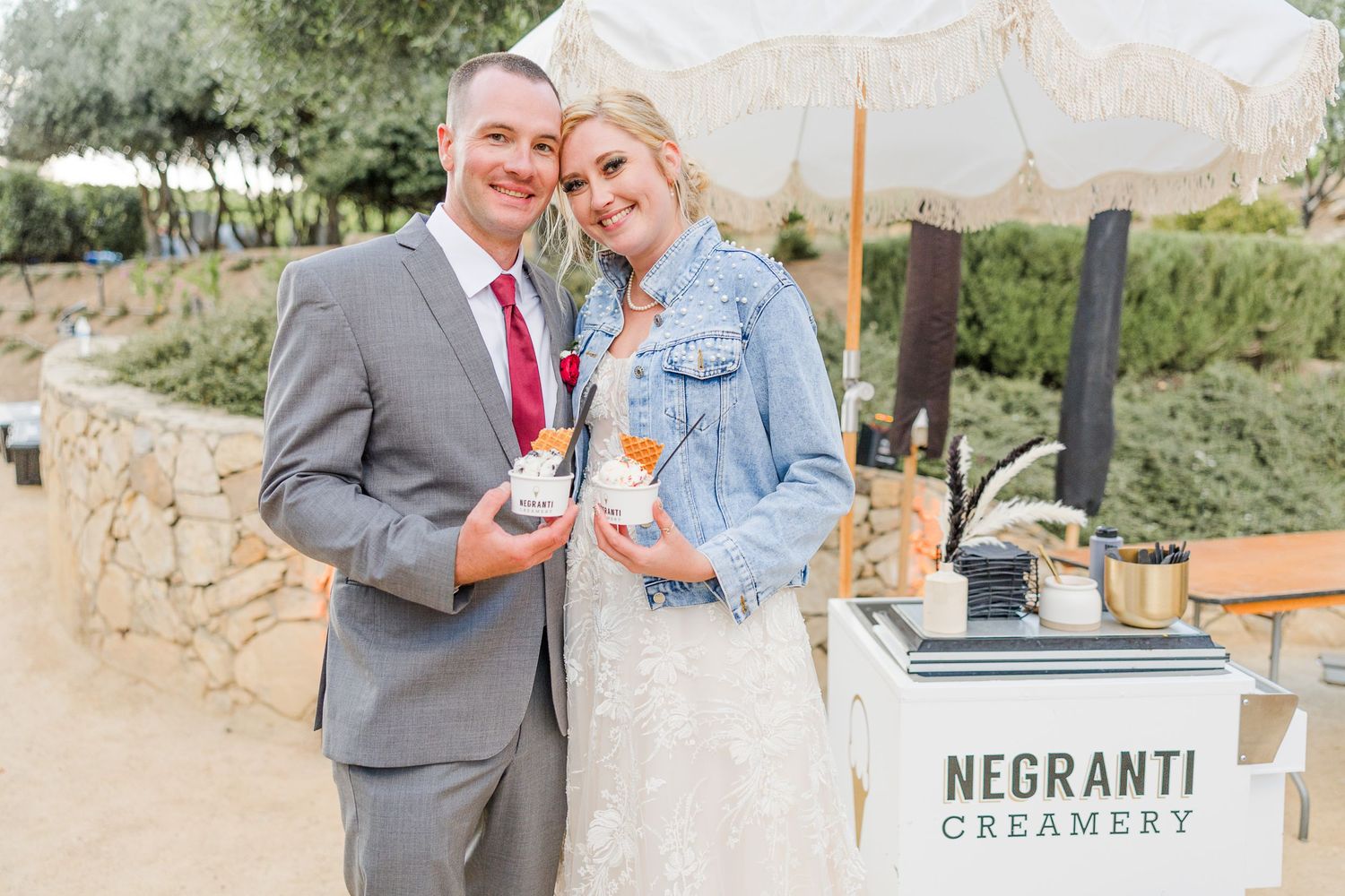 Couple enjoys ice cream from Negranti Creamery cart at their wedding reception.