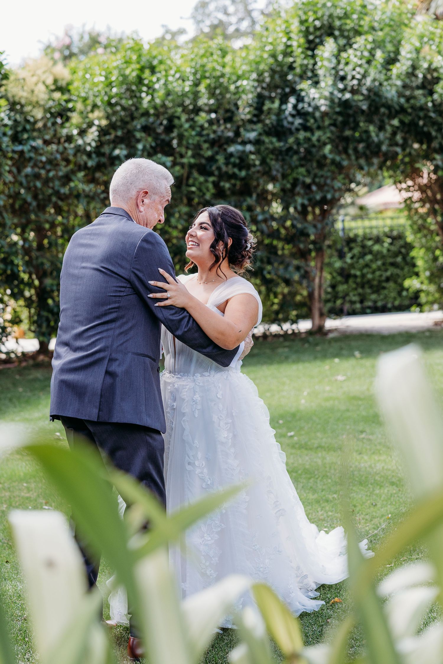 A heartwarming dance moment between a couple at their outdoor garden wedding.