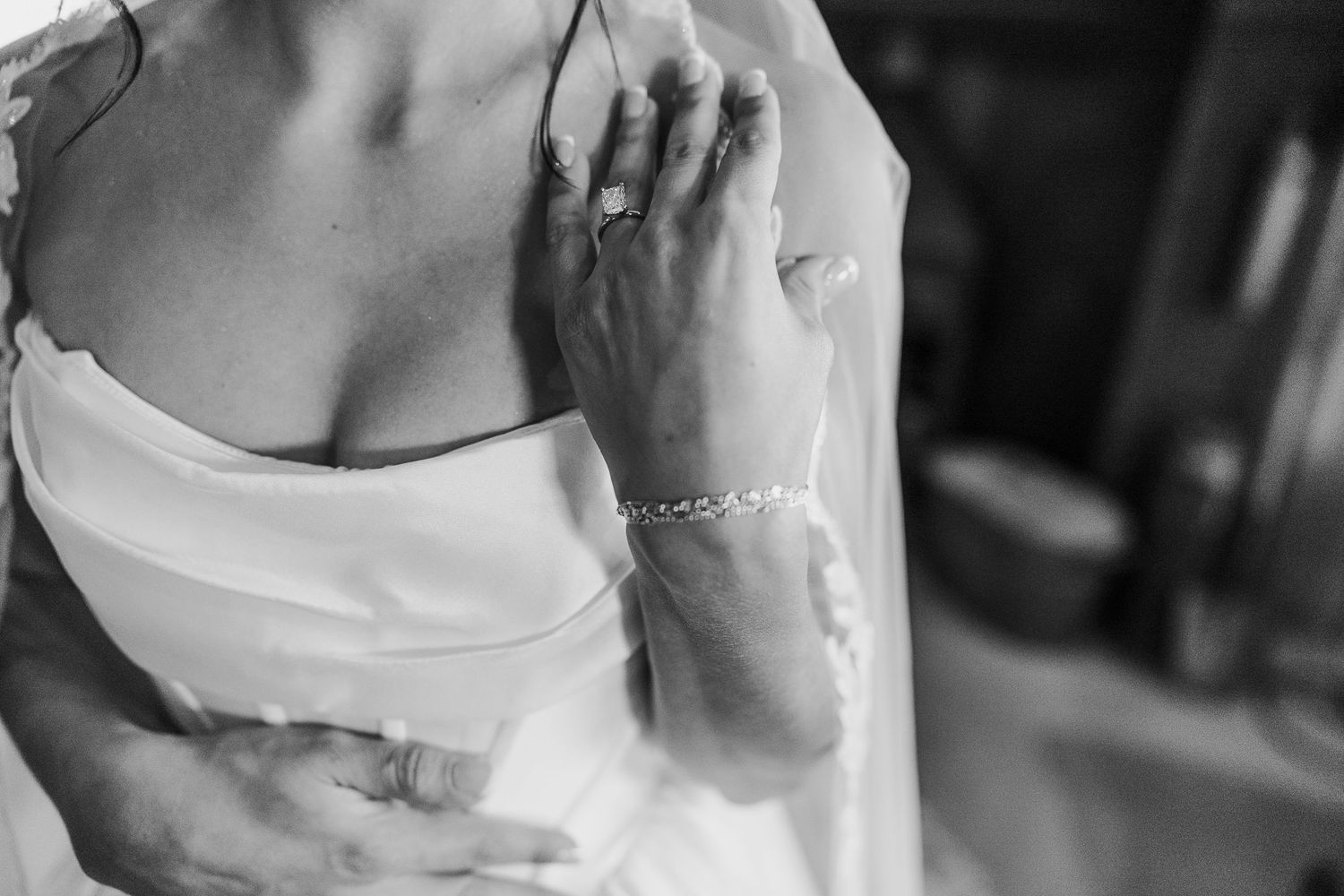 Close-up details of wedding dresses in white and cream colors with delicate fabric textures.