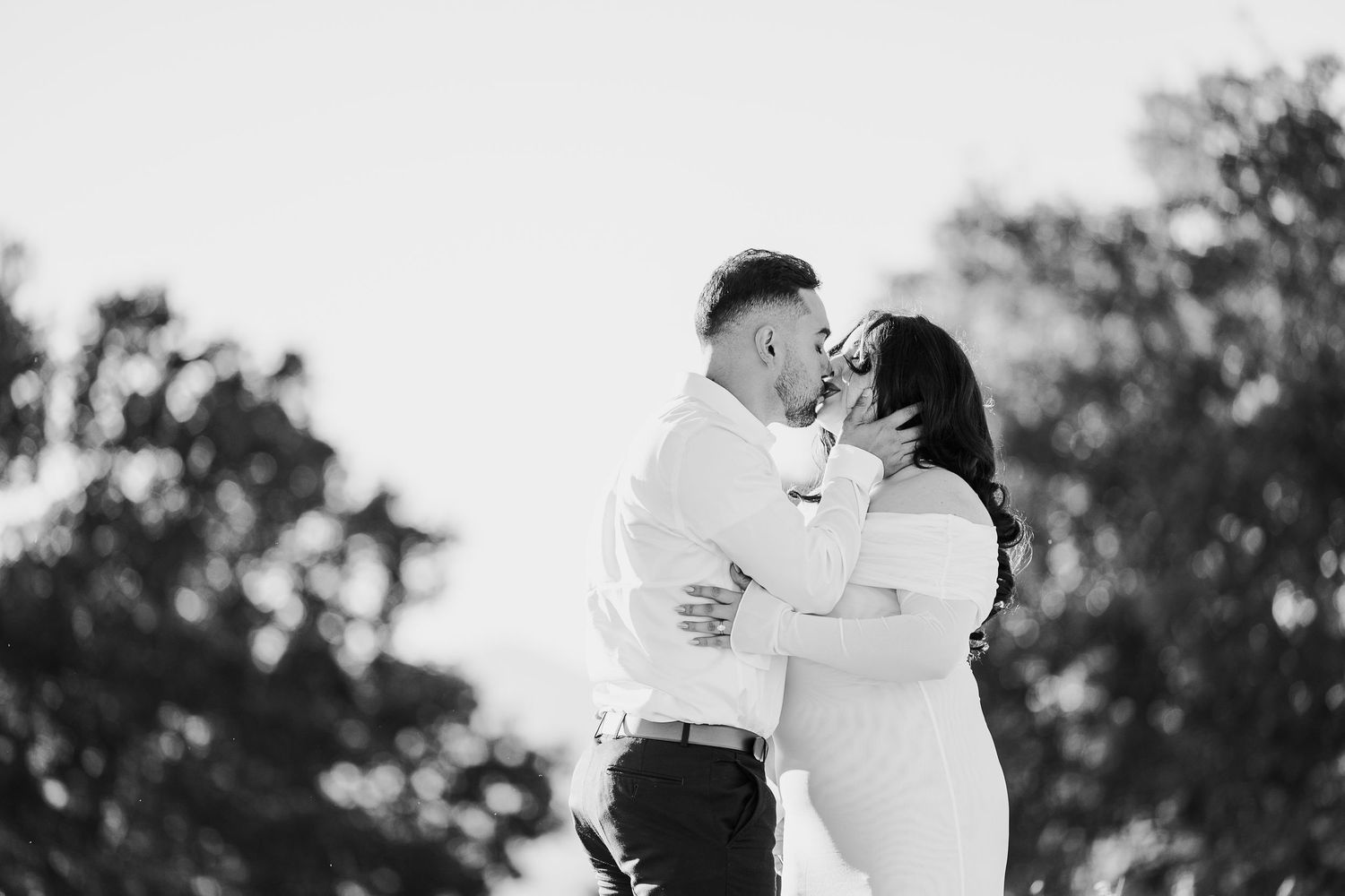 A romantic black and white photo montage showing intimate moments between a couple in an outdoor setting.
