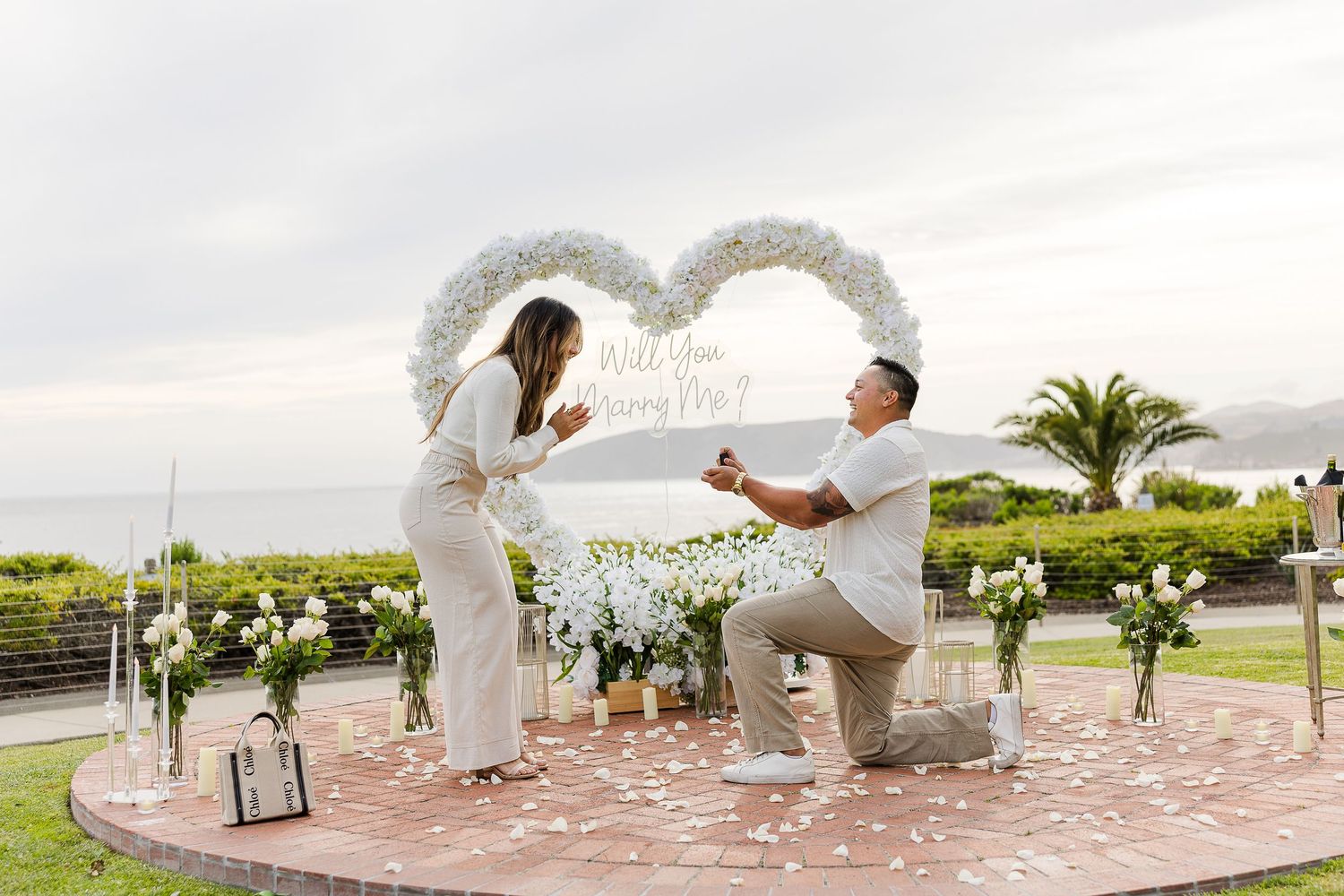 A series of wedding ceremony photos showing a white arch and chairs set up outdoors with palm trees and mountains visible.