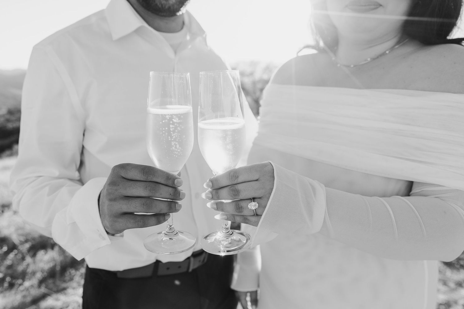 Wedding guests raise their glasses in a toast during an elegant reception celebration.