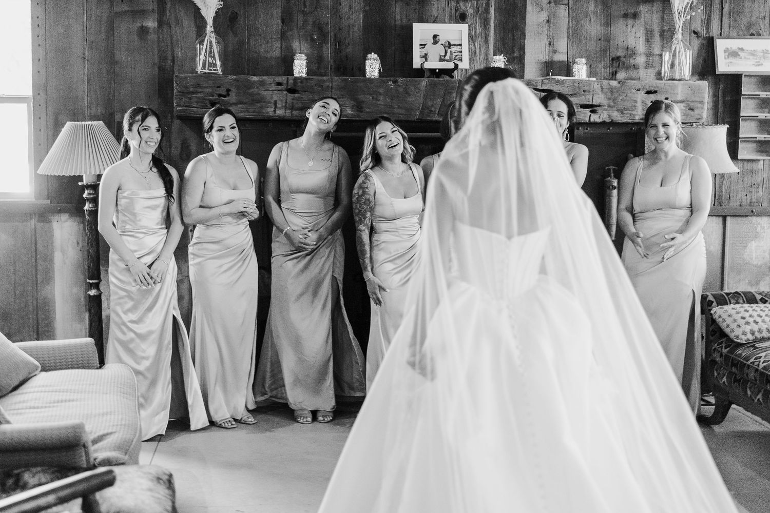 A wedding party poses in a black and white photo collage showing bridesmaids in light colored dresses and a bride in white.