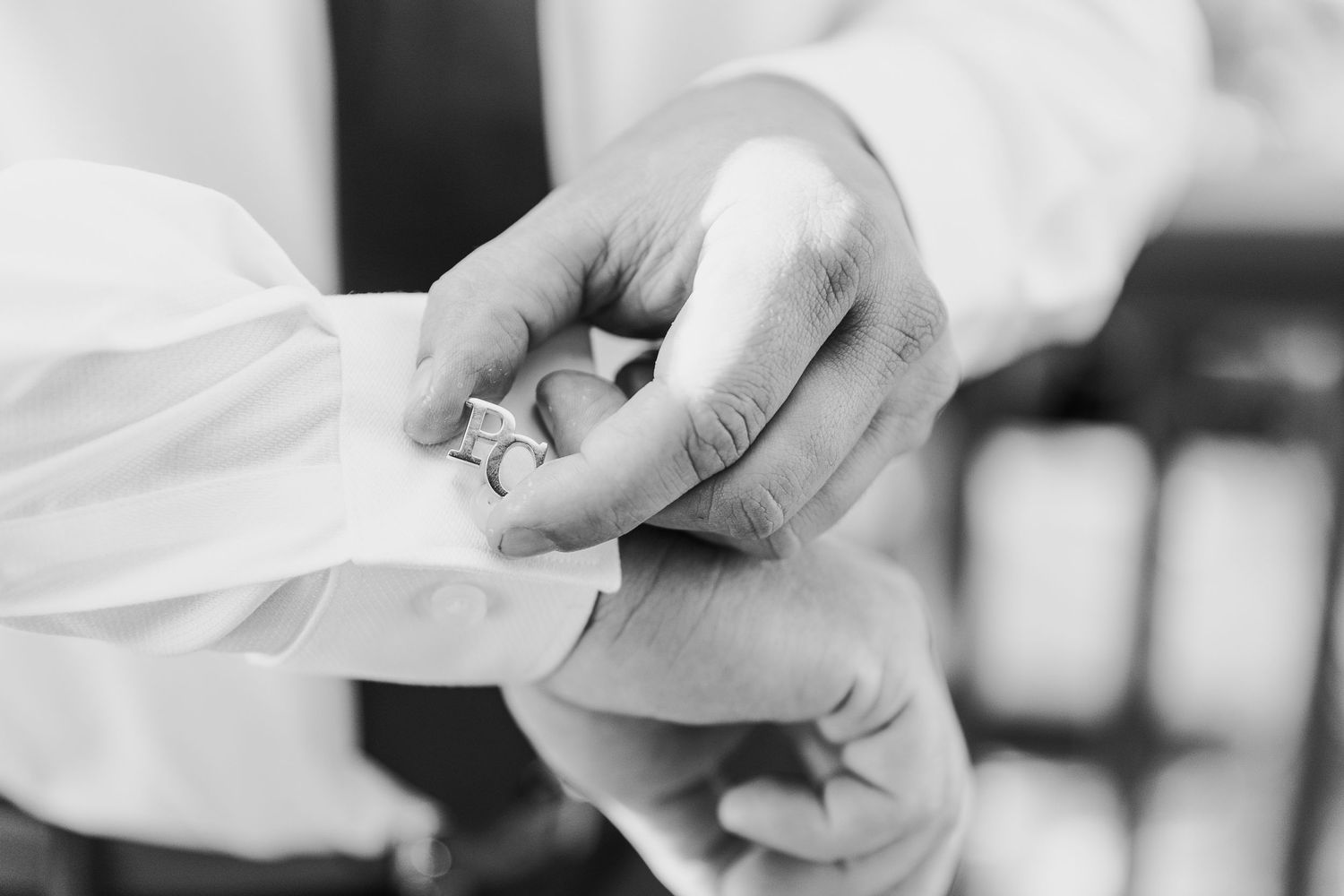 A close-up view of hands preparing fresh white dough on a floured surface.