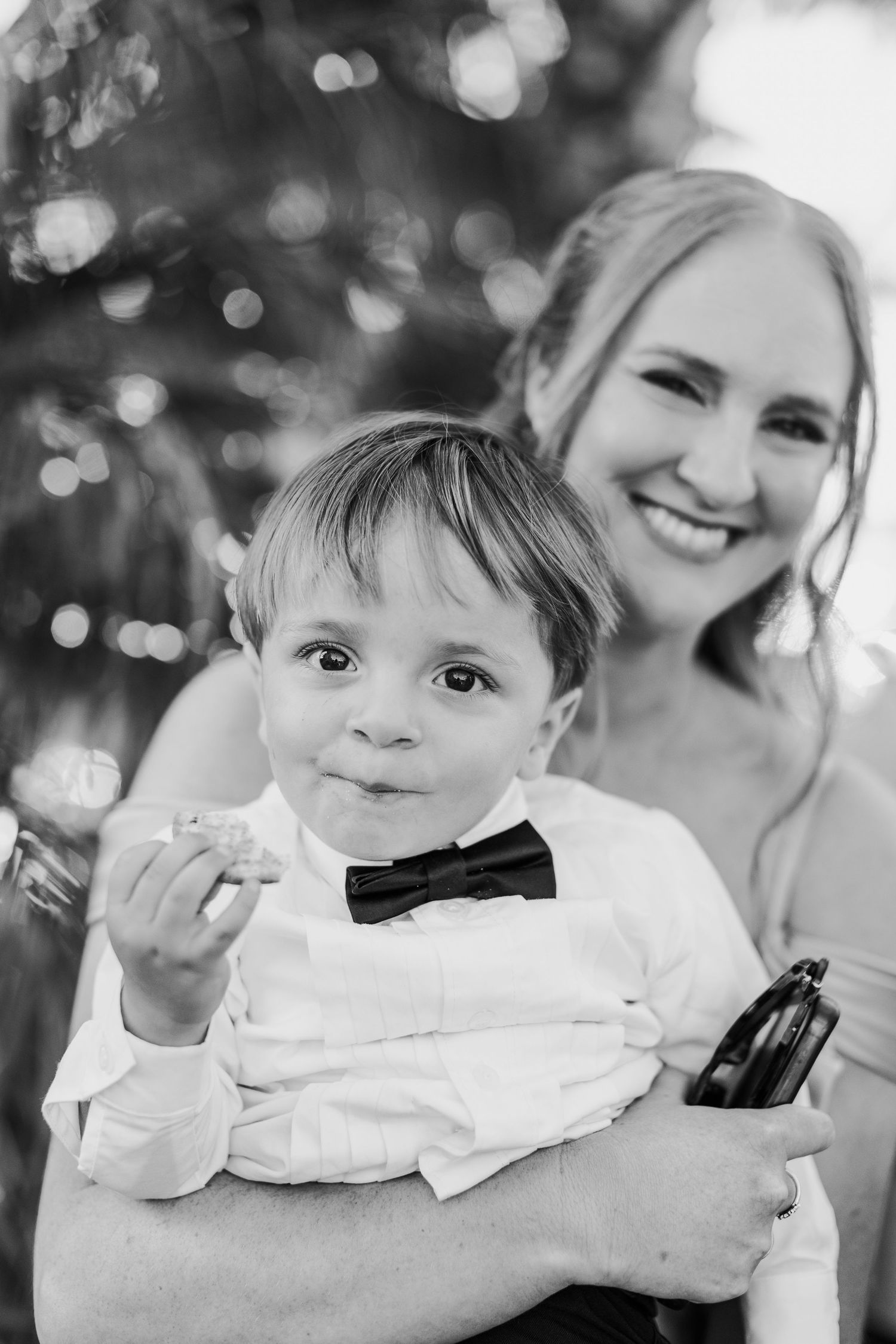 Black and white portraits showing playful expressions and smiles at a formal event.