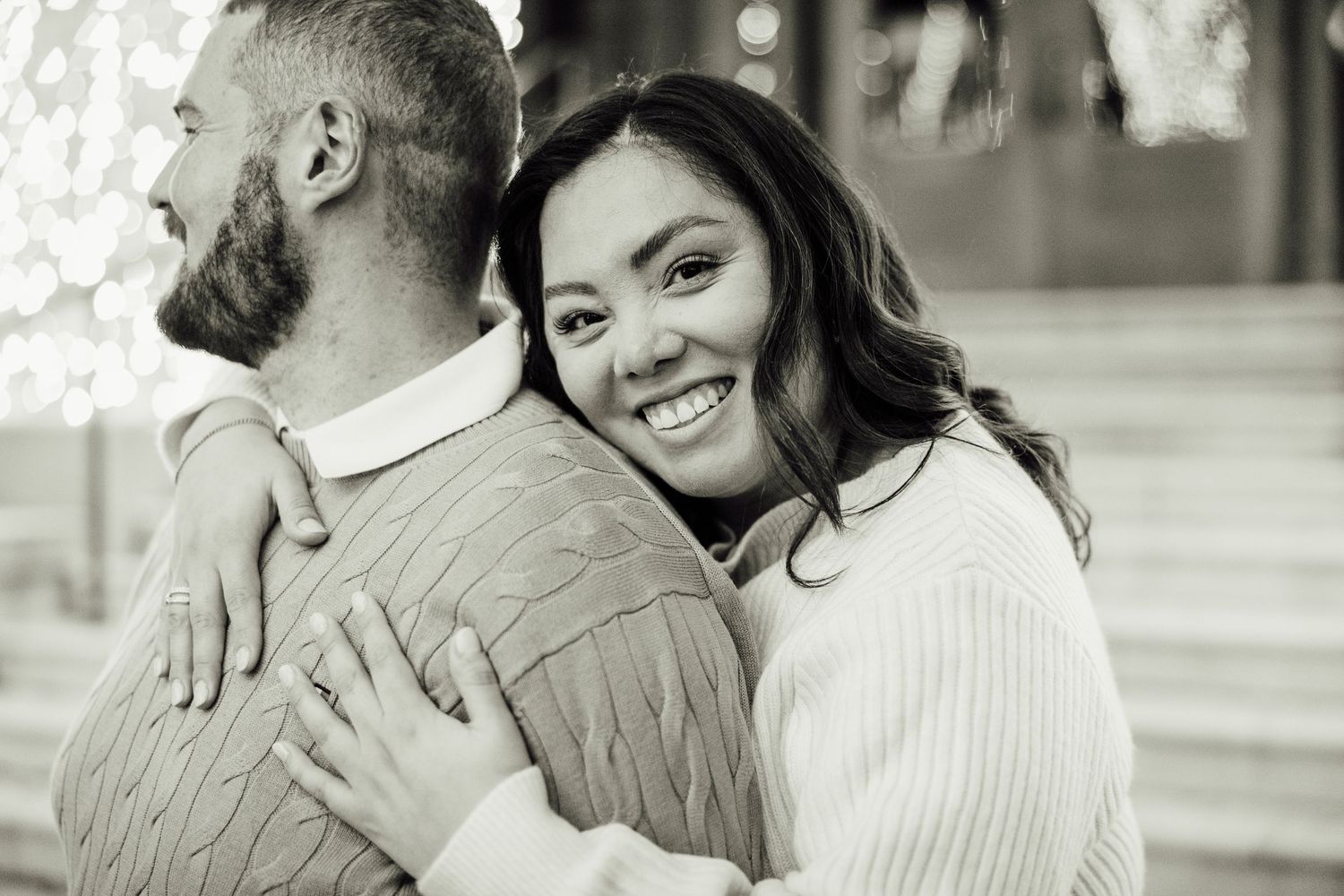 A couple shares intimate moments in a series of black and white photographs showing embraces and smiles.