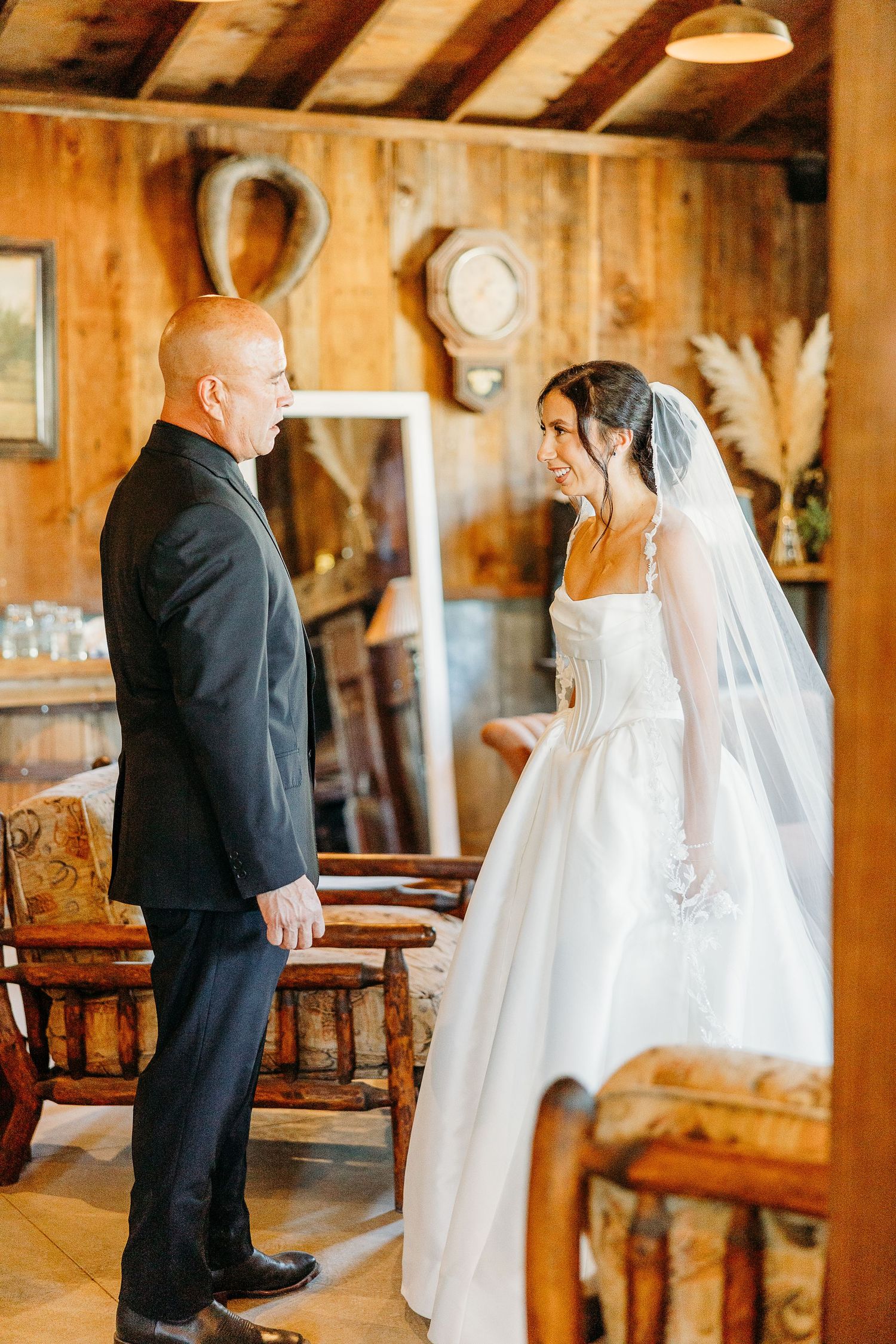 Wedding couple sharing intimate moments in a rustic wooden barn venue.