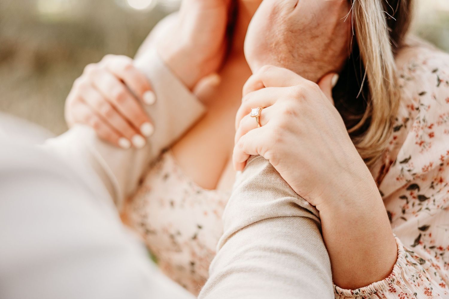Close up of hands embracing during an intimate outdoor photo session.