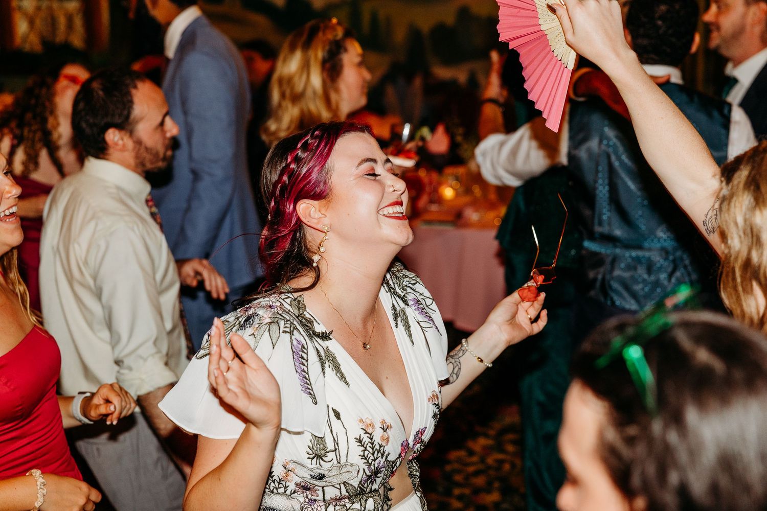 Wedding reception dance floor filled with joyful celebration and movement.