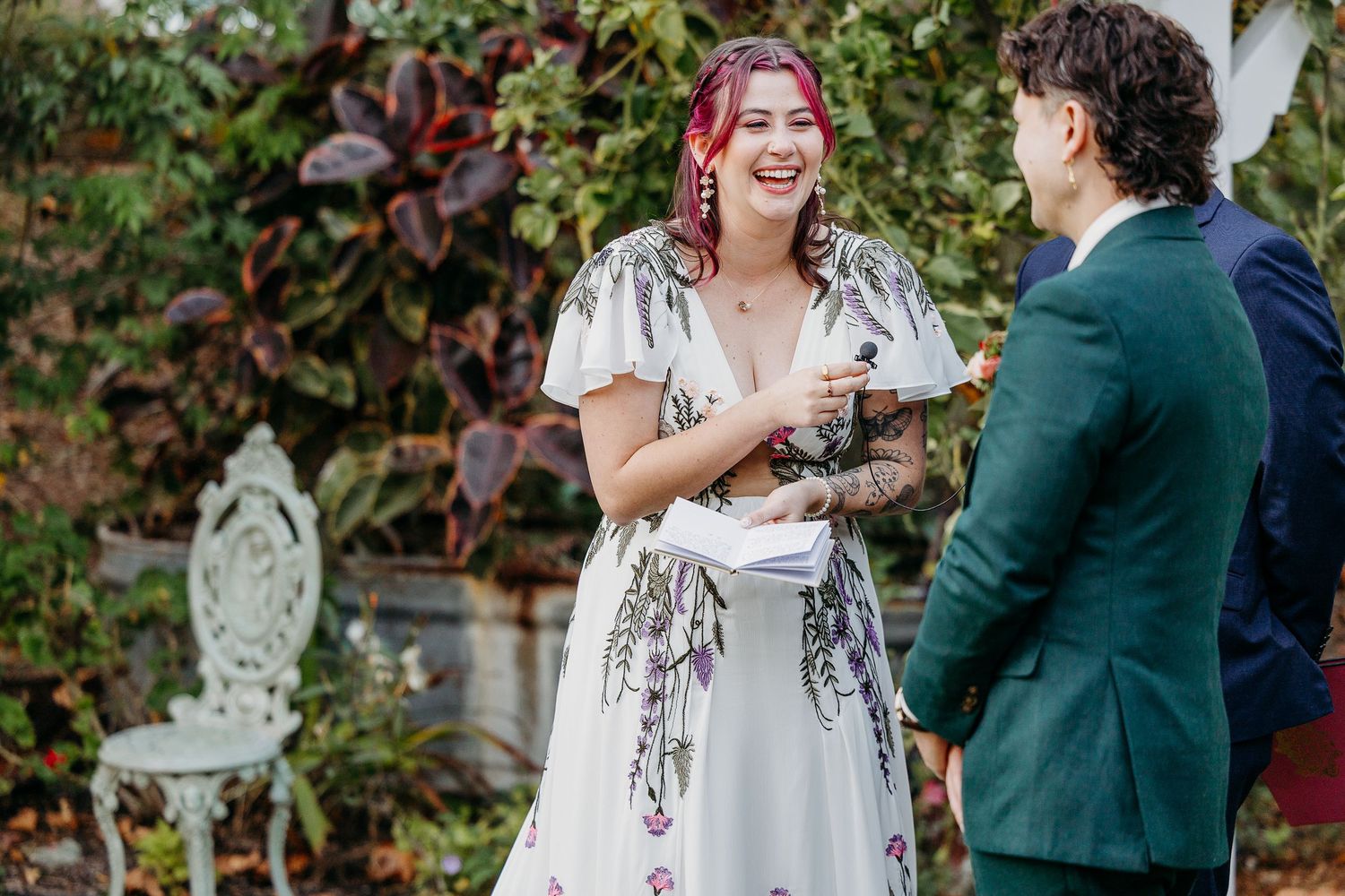 Wedding celebration in a garden setting with guests and decorative elements.