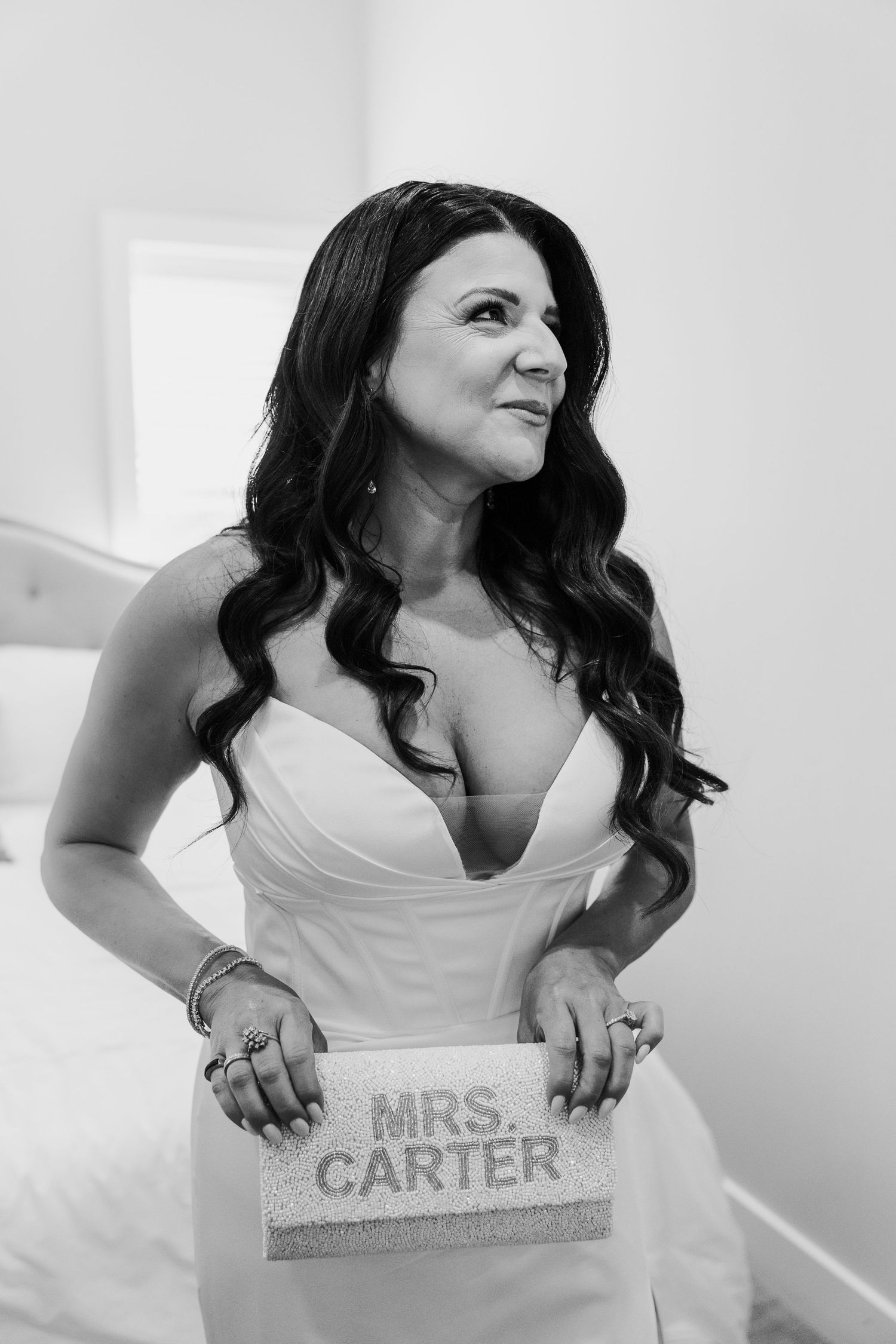 Bride in white dress reveals personalized 'Mrs. Carter' sign in stylish wedding photo sequence.