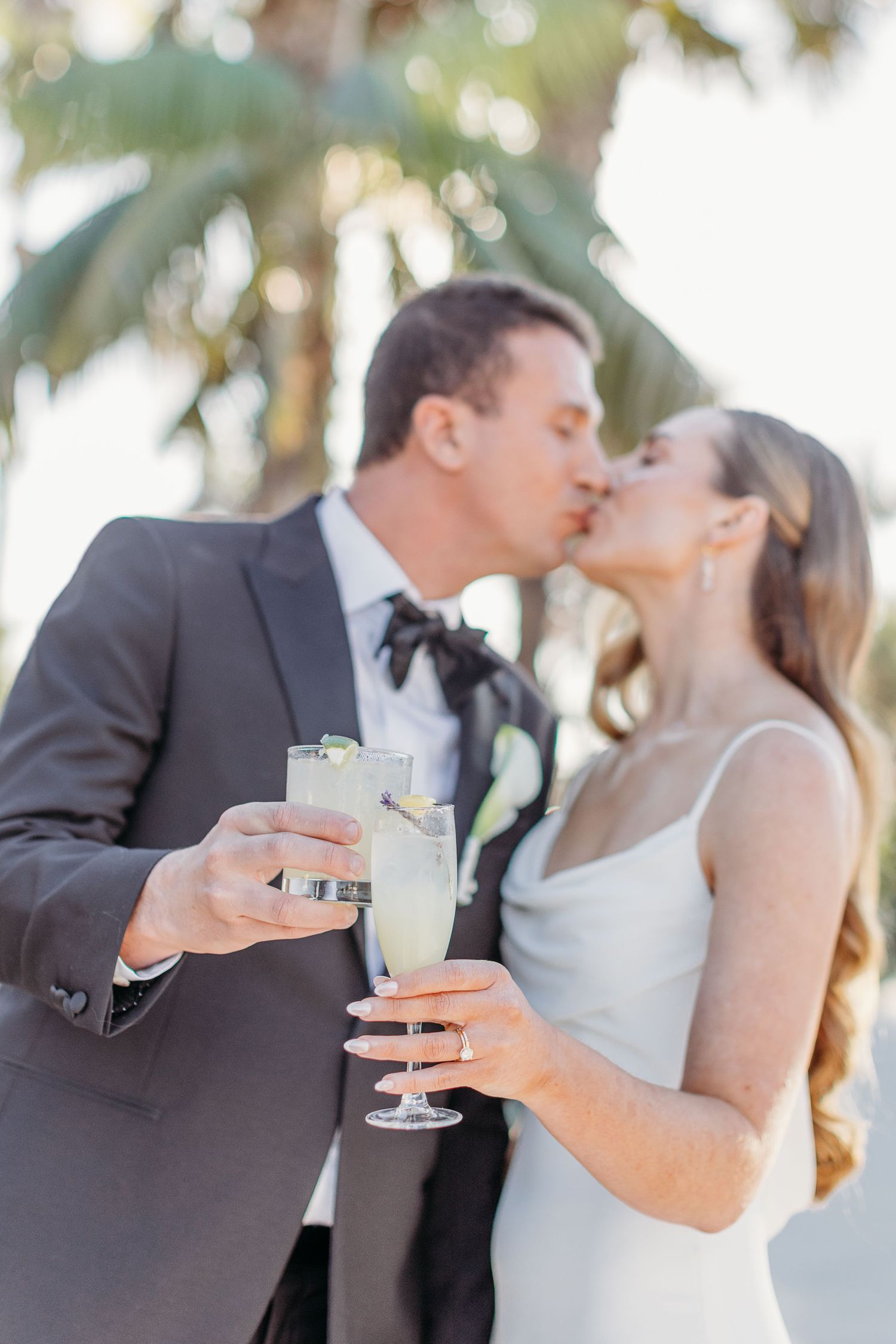 Newlyweds share champagne and a romantic moment during golden hour.