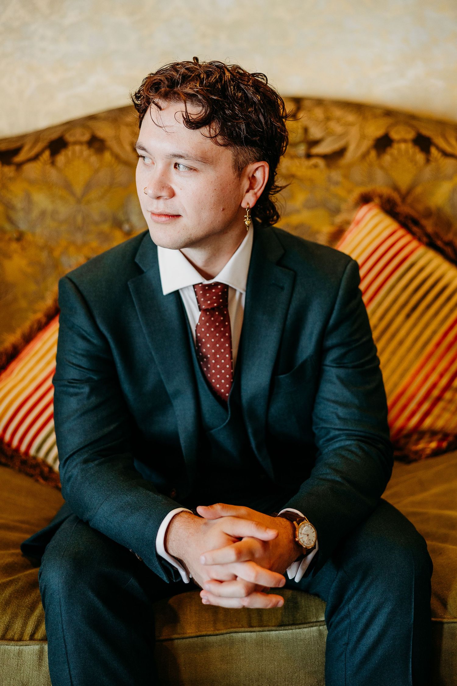 Sequential photos of person in dark suit sitting on patterned couch with vintage decor.