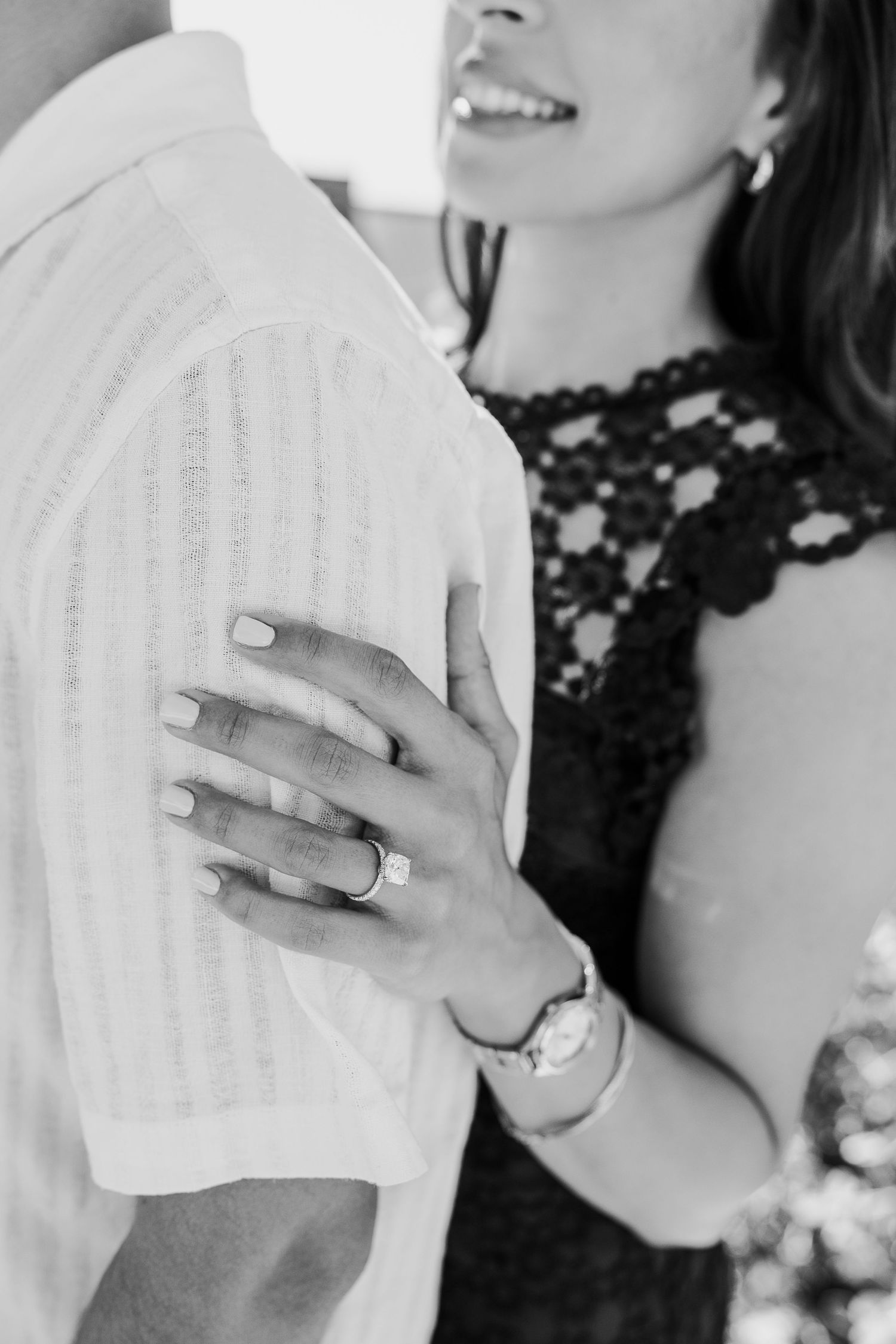 Close-up series showing hands with engagement ring in black and white photography.