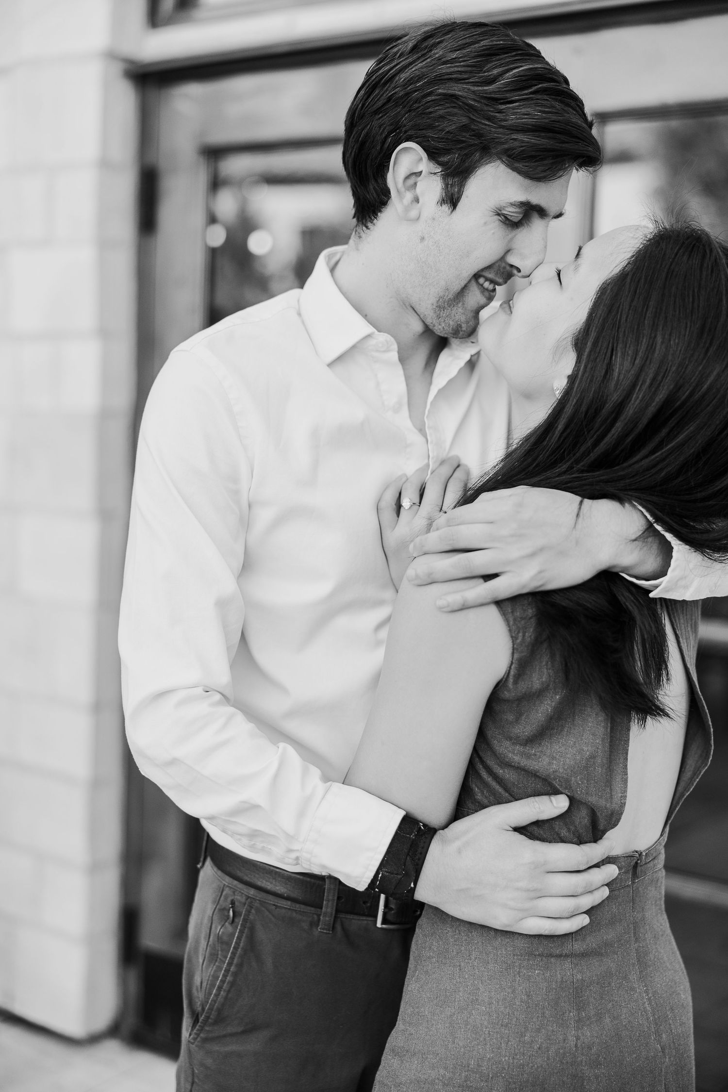 A romantic black and white photo of a tender embrace and intimate moment between a couple.