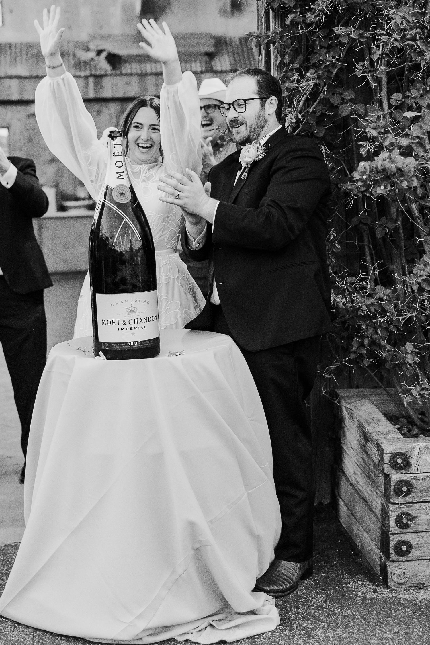 Newlyweds celebrating with champagne in formal attire during outdoor wedding reception in San Luis Obispo Holland Ranch.