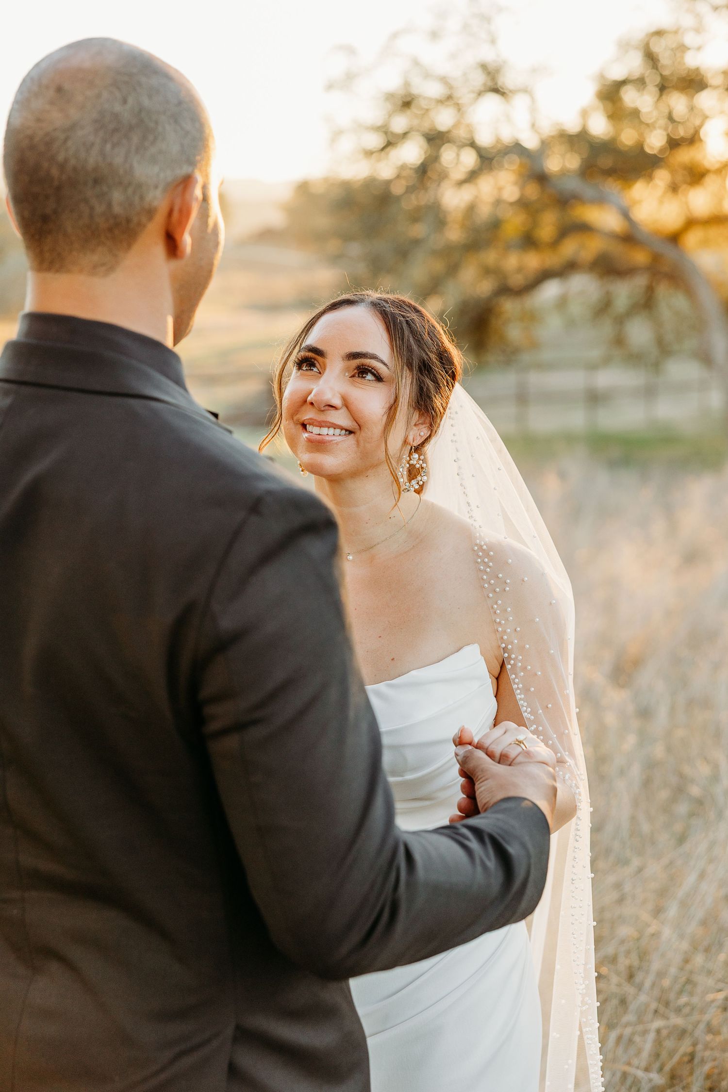 Candid wedding moments captured during sunset showing joyful interactions between the newlyweds.