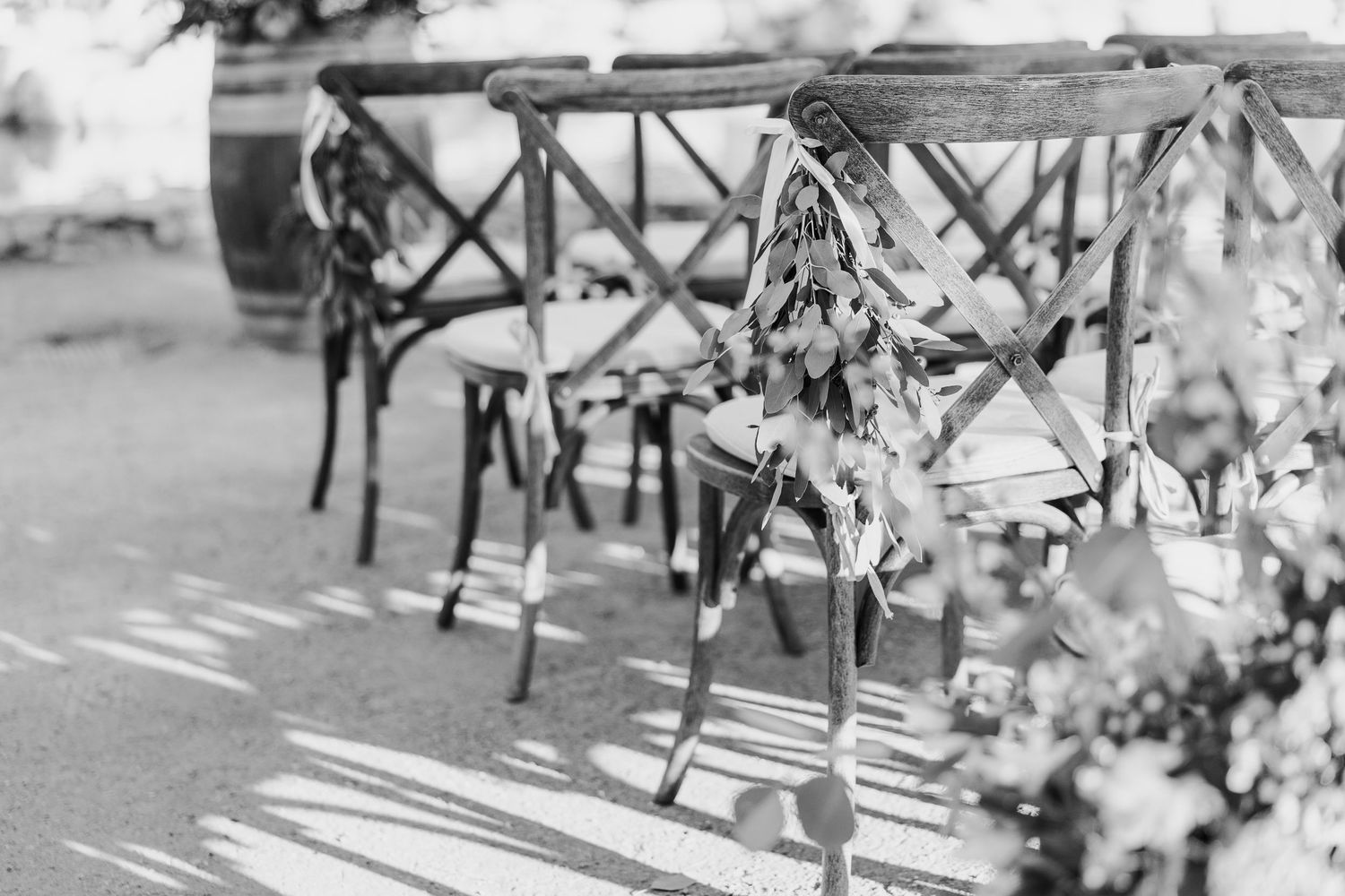 Elegant table settings with white linens and floral centerpieces at wedding reception.