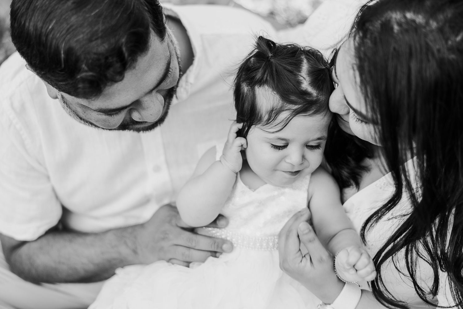 Intimate black and white close-up shots of family members sharing tender moments together.