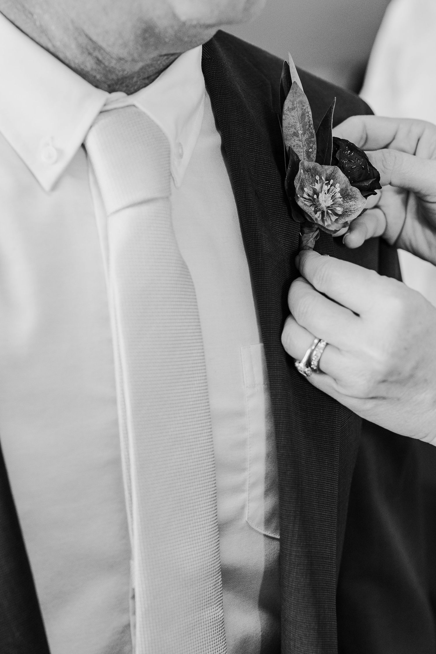 Close-up details of formal neckties and suit jackets in black and white.