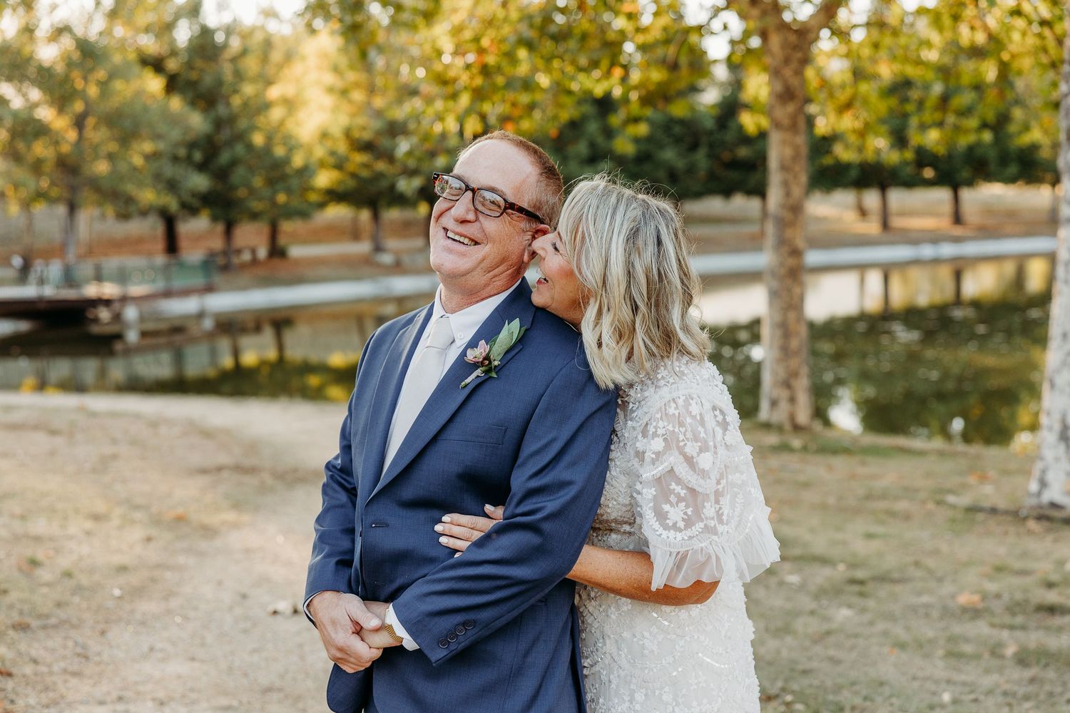Couple sharing a tender moment during their autumn outdoor wedding.